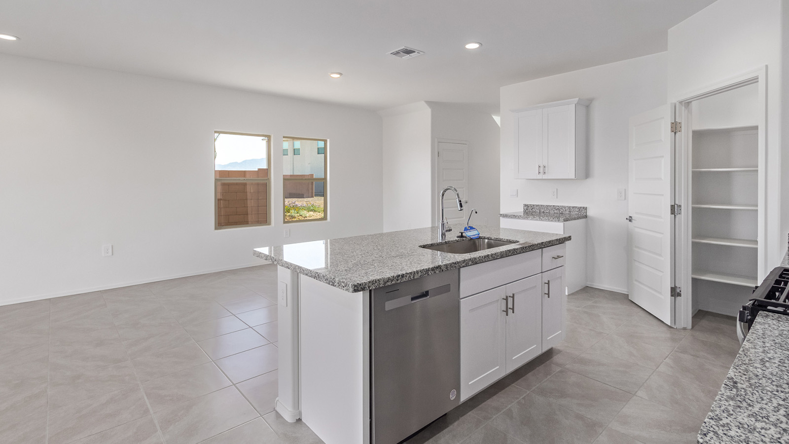 Welcome to The Madison, a generously sized two-story home located in the Mesquite neighborhood of Saguaro Bloom. With 2,522 square feet of living space, this home is designed to accommodate a variety of lifestyles, featuring five bedrooms and three full bathrooms.  As you step into the charming front porch, you are greeted by a spacious and open floor plan that seamlessly connects the main living areas. The great room serves as the central hub of the home, flowing into a dining area and modern kitchen area. The kitchen features a large central island, quartz countertops, Shaker-style cabinetry, walk-in pantry, and ample storage for all your culinary needs.  The first floor also includes a guest bedroom and a full bathroom, offering convenience and flexibility for visitors or family members.   Upstairs, The Madison continues to impress with a thoughtful layout that includes four additional bedrooms. The primary bedroom offers plenty of space ensuite a private bathroom and large walk-in closet. The loft area provides an additional living space that can be used as a game room, media center, or study, adding versatility to the home’s design.  A covered patio extends your living space outdoors, making it the perfect spot for enjoying the Arizona weather, whether you’re hosting a gathering or relaxing in the evening. The two-car garage provides ample space for vehicles and additional storage.  The Madison is equipped with modern, energy-efficient features and smart home technology, ensuring a comfortable and sustainable lifestyle for years to come. Large windows throughout the home allow natural light to fill the space, creating a warm and welcoming atmosphere.  Located in the vibrant Saguaro Bloom community, The Madison offers access to a wide range of amenities, including swimming pools, walking trails, parks, and more. This home combines style, comfort, and functionality, making it an excellent choice for those looking to settle in Marana.