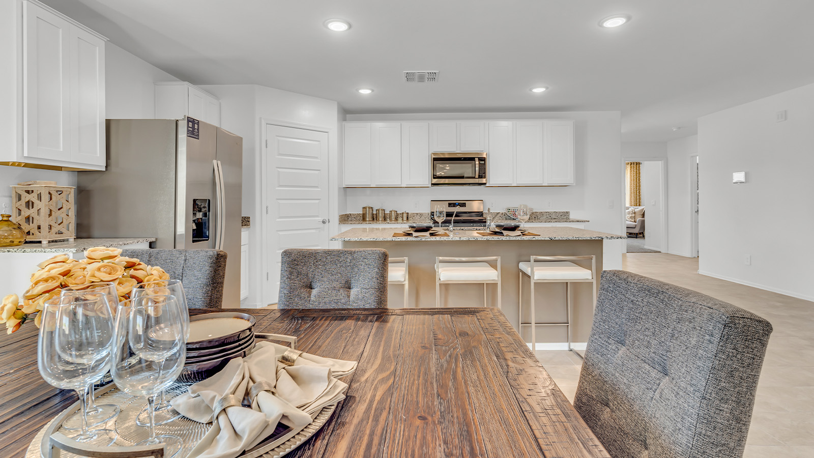 Welcome to the Gaven plan, a spacious single-story new home within Saguaro Bloom, where modern living meets the serene beauty of the Arizona landscape. This thoughtfully crafted residence offers 1,815 square feet of well-designed living space, featuring four bedrooms and two full bathrooms, perfect for families who value both comfort and style. As you step through the front door, you’ll be greeted by a bright and airy entryway that seamlessly transitions into the heart of the home. The open layout connects the great room, dining area, and kitchen, creating an ideal environment for both everyday living and entertaining. The kitchen is a culinary haven, equipped with state-of-the-art appliances, a spacious pantry, and elegant quartz countertops that extend to a large island, perfect for meal prep or casual dining.  The master suite, nestled at the rear of the home, offers a peaceful retreat with a generously sized walk-in closet and a luxurious en-suite bathroom. The additional three bedrooms are strategically placed to provide privacy and convenience, making them perfect for children, guests, or even a home office. Outside, the covered patio extends your living space into the beautifully landscaped backyard, ideal for enjoying Arizona’s stunning sunsets. The front yard is also fully landscaped and equipped with an auto drip irrigation system, ensuring your home’s curb appeal is maintained with ease.  Each home within Saguaro Bloom, including the Gaven plan, is outfitted with D.R. Horton’s Home is Connected® Smart Home package, featuring a smart thermostat, video doorbell, keyless entry, and Wi-Fi-enabled garage door opener. Energy efficiency is a cornerstone of the design, with features like spray foam insulation, tankless water heaters, and LED lighting, all contributing to long-term savings and environmental sustainability.  Saguaro Bloom isn’t just a place to live; it’s a vibrant community with a wealth of amenities, from scenic walking trails to pools and playgrounds, ensuring that there’s always something for everyone. Embrace the lifestyle you’ve always dreamed of in the Gaven plan—a perfect blend of comfort, convenience, and Arizona charm