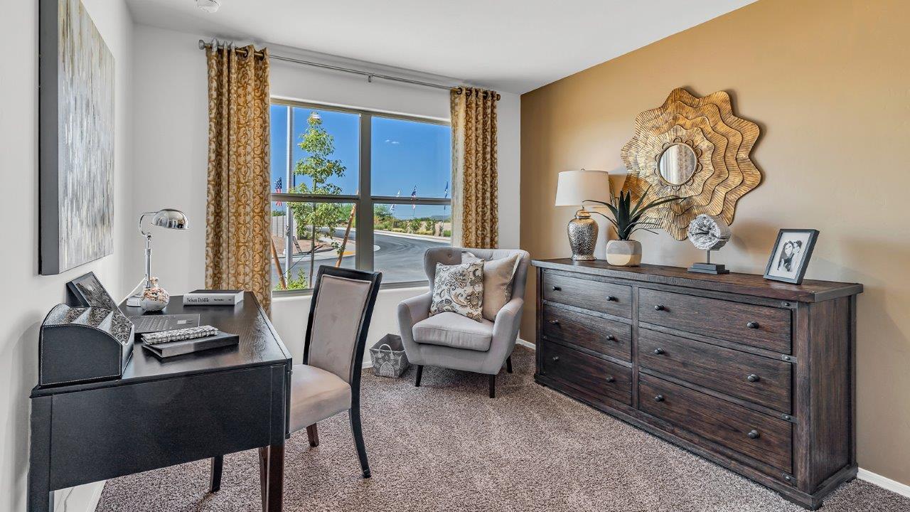 Welcome to the Gaven plan, a spacious single-story new home within Saguaro Bloom, where modern living meets the serene beauty of the Arizona landscape. This thoughtfully crafted residence offers 1,815 square feet of well-designed living space, featuring four bedrooms and two full bathrooms, perfect for families who value both comfort and style. As you step through the front door, you’ll be greeted by a bright and airy entryway that seamlessly transitions into the heart of the home. The open layout connects the great room, dining area, and kitchen, creating an ideal environment for both everyday living and entertaining. The kitchen is a culinary haven, equipped with state-of-the-art appliances, a spacious pantry, and elegant quartz countertops that extend to a large island, perfect for meal prep or casual dining.  The master suite, nestled at the rear of the home, offers a peaceful retreat with a generously sized walk-in closet and a luxurious en-suite bathroom. The additional three bedrooms are strategically placed to provide privacy and convenience, making them perfect for children, guests, or even a home office. Outside, the covered patio extends your living space into the beautifully landscaped backyard, ideal for enjoying Arizona’s stunning sunsets. The front yard is also fully landscaped and equipped with an auto drip irrigation system, ensuring your home’s curb appeal is maintained with ease.  Each home within Saguaro Bloom, including the Gaven plan, is outfitted with D.R. Horton’s Home is Connected® Smart Home package, featuring a smart thermostat, video doorbell, keyless entry, and Wi-Fi-enabled garage door opener. Energy efficiency is a cornerstone of the design, with features like spray foam insulation, tankless water heaters, and LED lighting, all contributing to long-term savings and environmental sustainability.  Saguaro Bloom isn’t just a place to live; it’s a vibrant community with a wealth of amenities, from scenic walking trails to pools and playgrounds, ensuring that there’s always something for everyone. Embrace the lifestyle you’ve always dreamed of in the Gaven plan—a perfect blend of comfort, convenience, and Arizona charm