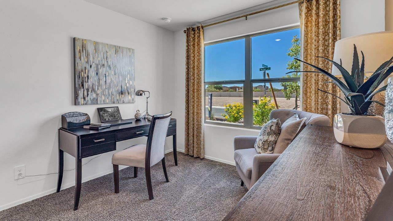 Welcome to the Gaven plan, a spacious single-story new home within Saguaro Bloom, where modern living meets the serene beauty of the Arizona landscape. This thoughtfully crafted residence offers 1,815 square feet of well-designed living space, featuring four bedrooms and two full bathrooms, perfect for families who value both comfort and style. As you step through the front door, you’ll be greeted by a bright and airy entryway that seamlessly transitions into the heart of the home. The open layout connects the great room, dining area, and kitchen, creating an ideal environment for both everyday living and entertaining. The kitchen is a culinary haven, equipped with state-of-the-art appliances, a spacious pantry, and elegant quartz countertops that extend to a large island, perfect for meal prep or casual dining.  The master suite, nestled at the rear of the home, offers a peaceful retreat with a generously sized walk-in closet and a luxurious en-suite bathroom. The additional three bedrooms are strategically placed to provide privacy and convenience, making them perfect for children, guests, or even a home office. Outside, the covered patio extends your living space into the beautifully landscaped backyard, ideal for enjoying Arizona’s stunning sunsets. The front yard is also fully landscaped and equipped with an auto drip irrigation system, ensuring your home’s curb appeal is maintained with ease.  Each home within Saguaro Bloom, including the Gaven plan, is outfitted with D.R. Horton’s Home is Connected® Smart Home package, featuring a smart thermostat, video doorbell, keyless entry, and Wi-Fi-enabled garage door opener. Energy efficiency is a cornerstone of the design, with features like spray foam insulation, tankless water heaters, and LED lighting, all contributing to long-term savings and environmental sustainability.  Saguaro Bloom isn’t just a place to live; it’s a vibrant community with a wealth of amenities, from scenic walking trails to pools and playgrounds, ensuring that there’s always something for everyone. Embrace the lifestyle you’ve always dreamed of in the Gaven plan—a perfect blend of comfort, convenience, and Arizona charm