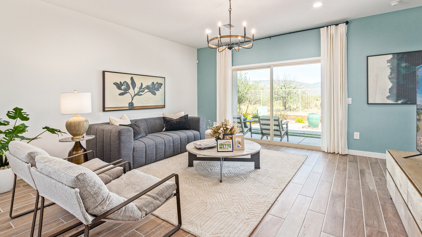 Welcome to The Gaven plan, a spacious single-story within Saguaro Bloom, where modern living meets the serene beauty of the Arizona landscape. This thoughtfully crafted layout offers 1,815 square feet of well-designed living space, featuring four bedrooms and two full bathrooms, perfect for families who value both comfort and style.  As you enter the home, you’ll be greeted by a bright and airy entryway that seamlessly transitions into the heart of the home. The open layout connects the great room, dining area, and kitchen area. The kitchen is a culinary haven, equipped with state-of-the-art appliances, a spacious pantry, and elegant quartz countertops that extend to a large island, perfect for meal prep or casual dining.  The primary suite, nestled at the rear of the home, offers a peaceful retreat with a generously sized walk-in closet and a luxurious en-suite bathroom. The additional three bedrooms are strategically placed to provide privacy and convenience, making them perfect for children, guests, or even a home office. Outside, the covered patio extends your living space, ideal for enjoying Arizona’s stunning sunsets. The front yard is fully landscaped and equipped with an auto drip irrigation system, ensuring your home’s curb appeal is maintained with ease.  Each home within Saguaro Bloom, is outfitted with D.R. Horton’s Home is Connected® Smart Home package, featuring a smart thermostat, video doorbell, keyless entry, and Wi-Fi-enabled garage door opener. Energy efficiency is a cornerstone of the design, with features like spray foam insulation, tankless water heater, and LED lighting, all contributing to long-term savings and environmental sustainability.  Saguaro Bloom is a vibrant community with a wealth of amenities, from scenic walking trails to pools and playgrounds, ensuring that there’s always something for everyone. Embrace the lifestyle you’ve always dreamed of in The Gaven — a perfect blend of comfort, convenience, and Arizona charm.  *Images shown are for reference only. They depict the sales model home and may not represent the actual home.