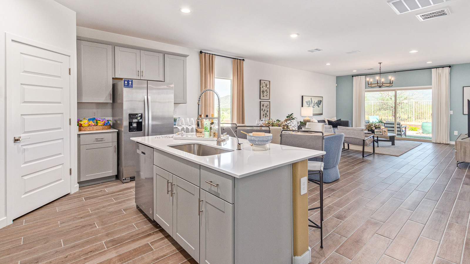 Welcome to The Gaven plan, a spacious single-story within Saguaro Bloom, where modern living meets the serene beauty of the Arizona landscape. This thoughtfully crafted layout offers 1,815 square feet of well-designed living space, featuring four bedrooms and two full bathrooms, perfect for families who value both comfort and style.  As you enter the home, you’ll be greeted by a bright and airy entryway that seamlessly transitions into the heart of the home. The open layout connects the great room, dining area, and kitchen area. The kitchen is a culinary haven, equipped with state-of-the-art appliances, a spacious pantry, and elegant quartz countertops that extend to a large island, perfect for meal prep or casual dining.  The primary suite, nestled at the rear of the home, offers a peaceful retreat with a generously sized walk-in closet and a luxurious en-suite bathroom. The additional three bedrooms are strategically placed to provide privacy and convenience, making them perfect for children, guests, or even a home office. Outside, the covered patio extends your living space, ideal for enjoying Arizona’s stunning sunsets. The front yard is fully landscaped and equipped with an auto drip irrigation system, ensuring your home’s curb appeal is maintained with ease.  Each home within Saguaro Bloom, is outfitted with D.R. Horton’s Home is Connected® Smart Home package, featuring a smart thermostat, video doorbell, keyless entry, and Wi-Fi-enabled garage door opener. Energy efficiency is a cornerstone of the design, with features like spray foam insulation, tankless water heater, and LED lighting, all contributing to long-term savings and environmental sustainability.  Saguaro Bloom is a vibrant community with a wealth of amenities, from scenic walking trails to pools and playgrounds, ensuring that there’s always something for everyone. Embrace the lifestyle you’ve always dreamed of in The Gaven — a perfect blend of comfort, convenience, and Arizona charm.  *Images shown are for reference only. They depict the sales model home and may not represent the actual home.