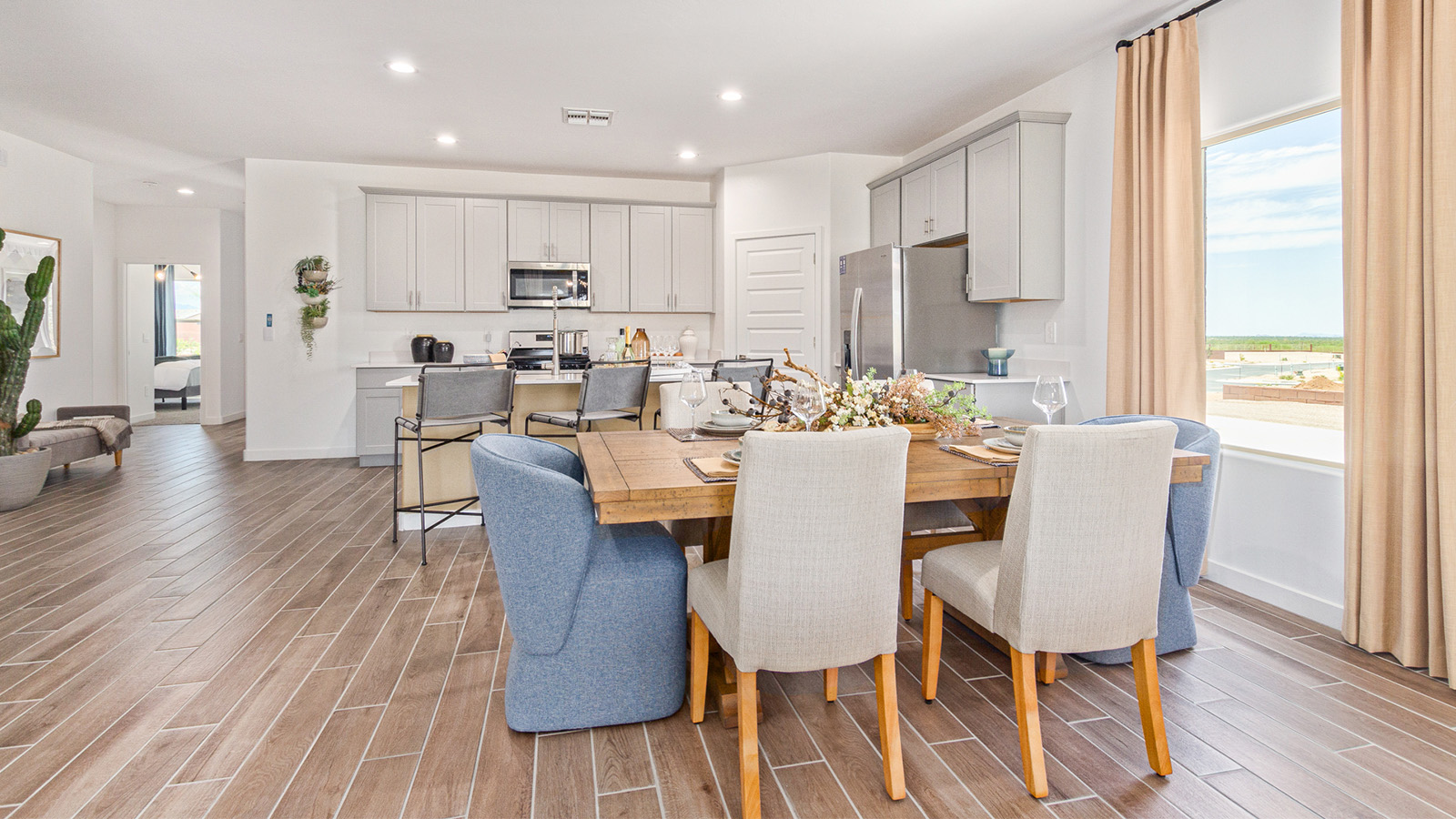 Welcome to The Gaven plan, a spacious single-story within Saguaro Bloom, where modern living meets the serene beauty of the Arizona landscape. This thoughtfully crafted layout offers 1,815 square feet of well-designed living space, featuring four bedrooms and two full bathrooms, perfect for families who value both comfort and style.  As you enter the home, you’ll be greeted by a bright and airy entryway that seamlessly transitions into the heart of the home. The open layout connects the great room, dining area, and kitchen area. The kitchen is a culinary haven, equipped with state-of-the-art appliances, a spacious pantry, and elegant quartz countertops that extend to a large island, perfect for meal prep or casual dining.  The primary suite, nestled at the rear of the home, offers a peaceful retreat with a generously sized walk-in closet and a luxurious en-suite bathroom. The additional three bedrooms are strategically placed to provide privacy and convenience, making them perfect for children, guests, or even a home office. Outside, the covered patio extends your living space, ideal for enjoying Arizona’s stunning sunsets. The front yard is fully landscaped and equipped with an auto drip irrigation system, ensuring your home’s curb appeal is maintained with ease.  Each home within Saguaro Bloom, is outfitted with D.R. Horton’s Home is Connected® Smart Home package, featuring a smart thermostat, video doorbell, keyless entry, and Wi-Fi-enabled garage door opener. Energy efficiency is a cornerstone of the design, with features like spray foam insulation, tankless water heater, and LED lighting, all contributing to long-term savings and environmental sustainability.  Saguaro Bloom is a vibrant community with a wealth of amenities, from scenic walking trails to pools and playgrounds, ensuring that there’s always something for everyone. Embrace the lifestyle you’ve always dreamed of in The Gaven — a perfect blend of comfort, convenience, and Arizona charm.  *Images shown are for reference only. They depict the Gaven model home and may not represent the actual home.