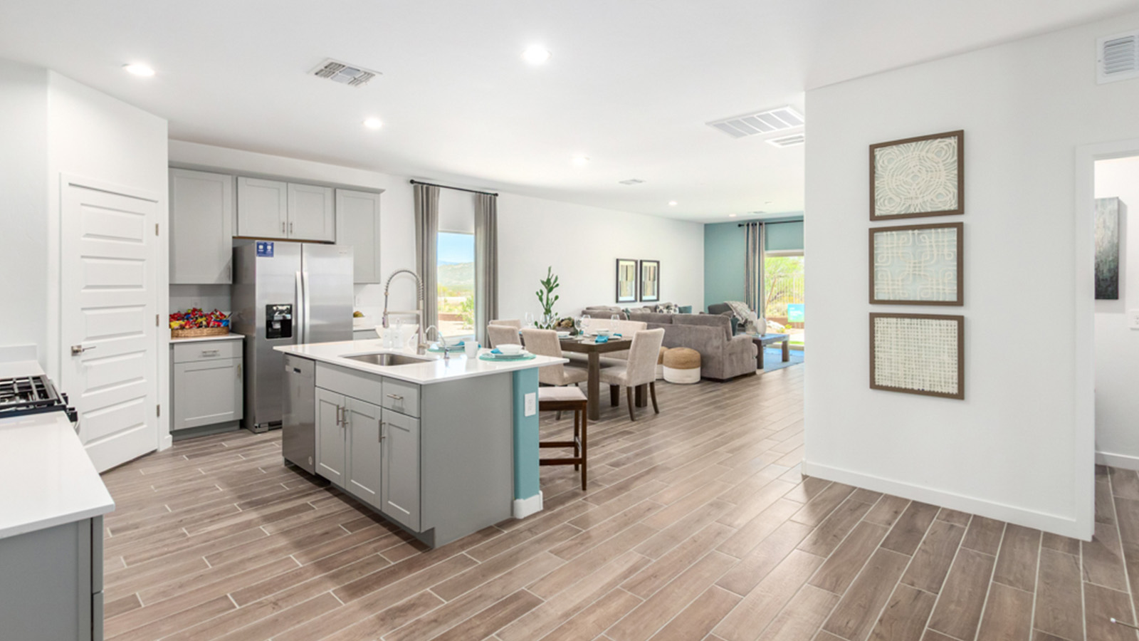 Welcome to The Gaven plan, a spacious single-story within Saguaro Bloom, where modern living meets the serene beauty of the Arizona landscape. This thoughtfully crafted layout offers 1,815 square feet of well-designed living space, featuring four bedrooms and two full bathrooms, perfect for families who value both comfort and style.  As you enter the home, you’ll be greeted by a bright and airy entryway that seamlessly transitions into the heart of the home. The open layout connects the great room, dining area, and kitchen area. The kitchen is a culinary haven, equipped with state-of-the-art appliances, a spacious pantry, and elegant quartz countertops that extend to a large island, perfect for meal prep or casual dining.  The primary suite, nestled at the rear of the home, offers a peaceful retreat with a generously sized walk-in closet and a luxurious en-suite bathroom. The additional three bedrooms are strategically placed to provide privacy and convenience, making them perfect for children, guests, or even a home office. Outside, the covered patio extends your living space, ideal for enjoying Arizona’s stunning sunsets. The front yard is fully landscaped and equipped with an auto drip irrigation system, ensuring your home’s curb appeal is maintained with ease.  Each home within Saguaro Bloom, is outfitted with D.R. Horton’s Home is Connected® Smart Home package, featuring a smart thermostat, video doorbell, keyless entry, and Wi-Fi-enabled garage door opener. Energy efficiency is a cornerstone of the design, with features like spray foam insulation, tankless water heater, and LED lighting, all contributing to long-term savings and environmental sustainability.  Saguaro Bloom is a vibrant community with a wealth of amenities, from scenic walking trails to pools and playgrounds, ensuring that there’s always something for everyone. Embrace the lifestyle you’ve always dreamed of in The Gaven — a perfect blend of comfort, convenience, and Arizona charm.  *Images shown are for reference only. They depict the Gaven Model home and may not represent the actual home.