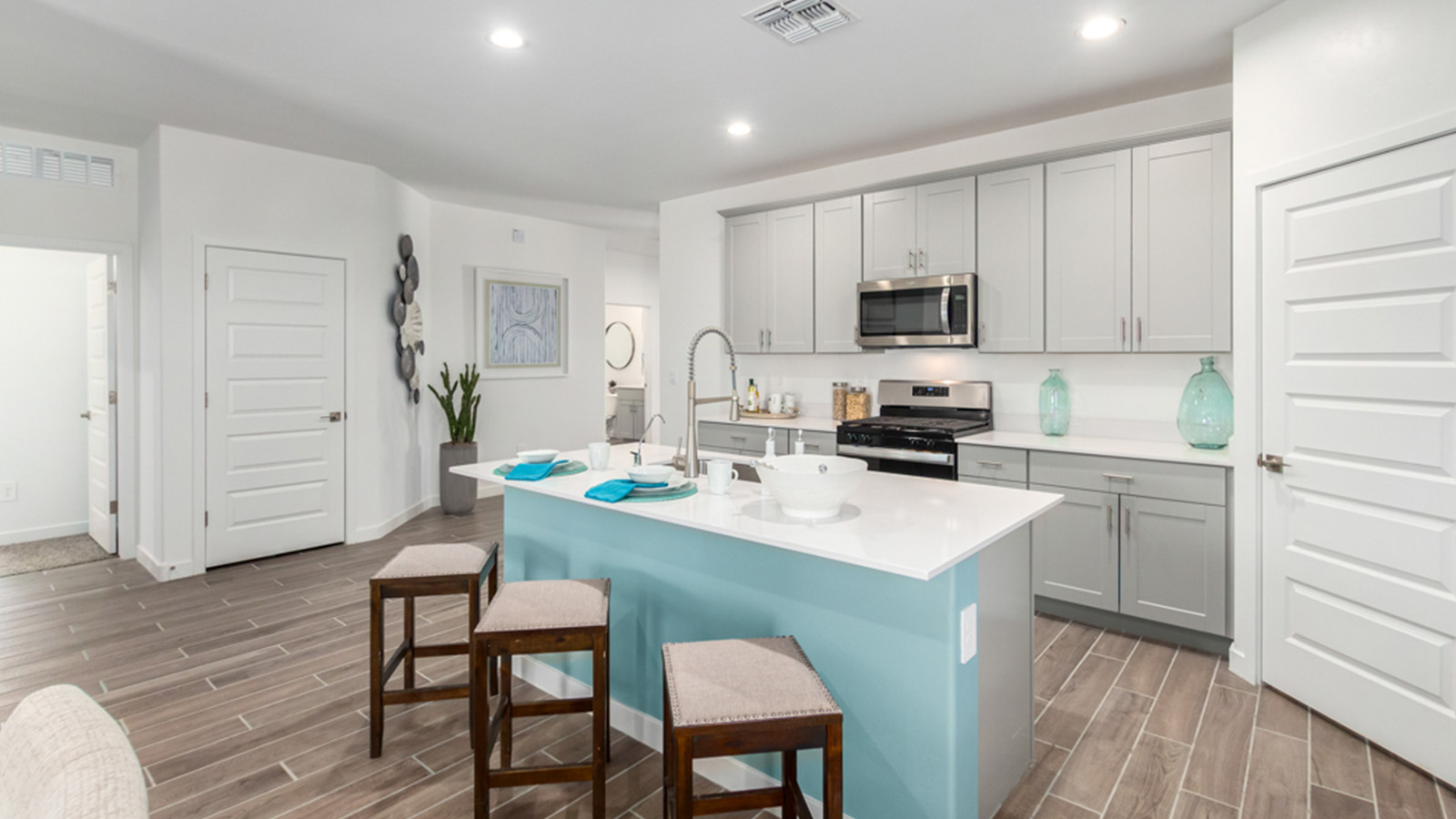 Welcome to The Gaven plan, a spacious single-story within Saguaro Bloom, where modern living meets the serene beauty of the Arizona landscape. This thoughtfully crafted layout offers 1,815 square feet of well-designed living space, featuring four bedrooms and two full bathrooms, perfect for families who value both comfort and style.  As you enter the home, you’ll be greeted by a bright and airy entryway that seamlessly transitions into the heart of the home. The open layout connects the great room, dining area, and kitchen area. The kitchen is a culinary haven, equipped with state-of-the-art appliances, a spacious pantry, and elegant quartz countertops that extend to a large island, perfect for meal prep or casual dining.  The primary suite, nestled at the rear of the home, offers a peaceful retreat with a generously sized walk-in closet and a luxurious en-suite bathroom. The additional three bedrooms are strategically placed to provide privacy and convenience, making them perfect for children, guests, or even a home office. Outside, the covered patio extends your living space, ideal for enjoying Arizona’s stunning sunsets. The front yard is fully landscaped and equipped with an auto drip irrigation system, ensuring your home’s curb appeal is maintained with ease.  Each home within Saguaro Bloom, is outfitted with D.R. Horton’s Home is Connected® Smart Home package, featuring a smart thermostat, video doorbell, keyless entry, and Wi-Fi-enabled garage door opener. Energy efficiency is a cornerstone of the design, with features like spray foam insulation, tankless water heater, and LED lighting, all contributing to long-term savings and environmental sustainability.  Saguaro Bloom is a vibrant community with a wealth of amenities, from scenic walking trails to pools and playgrounds, ensuring that there’s always something for everyone. Embrace the lifestyle you’ve always dreamed of in The Gaven — a perfect blend of comfort, convenience, and Arizona charm.  *Images shown are for reference only. They depict the Gaven Model home and may not represent the actual home.