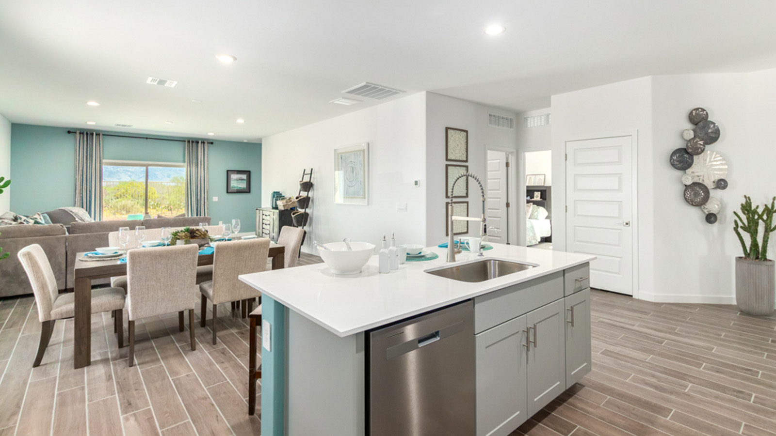 Welcome to The Gaven plan, a spacious single-story within Saguaro Bloom, where modern living meets the serene beauty of the Arizona landscape. This thoughtfully crafted layout offers 1,815 square feet of well-designed living space, featuring four bedrooms and two full bathrooms, perfect for families who value both comfort and style.  As you enter the home, you’ll be greeted by a bright and airy entryway that seamlessly transitions into the heart of the home. The open layout connects the great room, dining area, and kitchen area. The kitchen is a culinary haven, equipped with state-of-the-art appliances, a spacious pantry, and elegant quartz countertops that extend to a large island, perfect for meal prep or casual dining.  The primary suite, nestled at the rear of the home, offers a peaceful retreat with a generously sized walk-in closet and a luxurious en-suite bathroom. The additional three bedrooms are strategically placed to provide privacy and convenience, making them perfect for children, guests, or even a home office. Outside, the covered patio extends your living space, ideal for enjoying Arizona’s stunning sunsets. The front yard is fully landscaped and equipped with an auto drip irrigation system, ensuring your home’s curb appeal is maintained with ease.  Each home within Saguaro Bloom, is outfitted with D.R. Horton’s Home is Connected® Smart Home package, featuring a smart thermostat, video doorbell, keyless entry, and Wi-Fi-enabled garage door opener. Energy efficiency is a cornerstone of the design, with features like spray foam insulation, tankless water heater, and LED lighting, all contributing to long-term savings and environmental sustainability.  Saguaro Bloom is a vibrant community with a wealth of amenities, from scenic walking trails to pools and playgrounds, ensuring that there’s always something for everyone. Embrace the lifestyle you’ve always dreamed of in The Gaven — a perfect blend of comfort, convenience, and Arizona charm.  *Images shown are for reference only. They depict the Gaven Model home and may not represent the actual home.