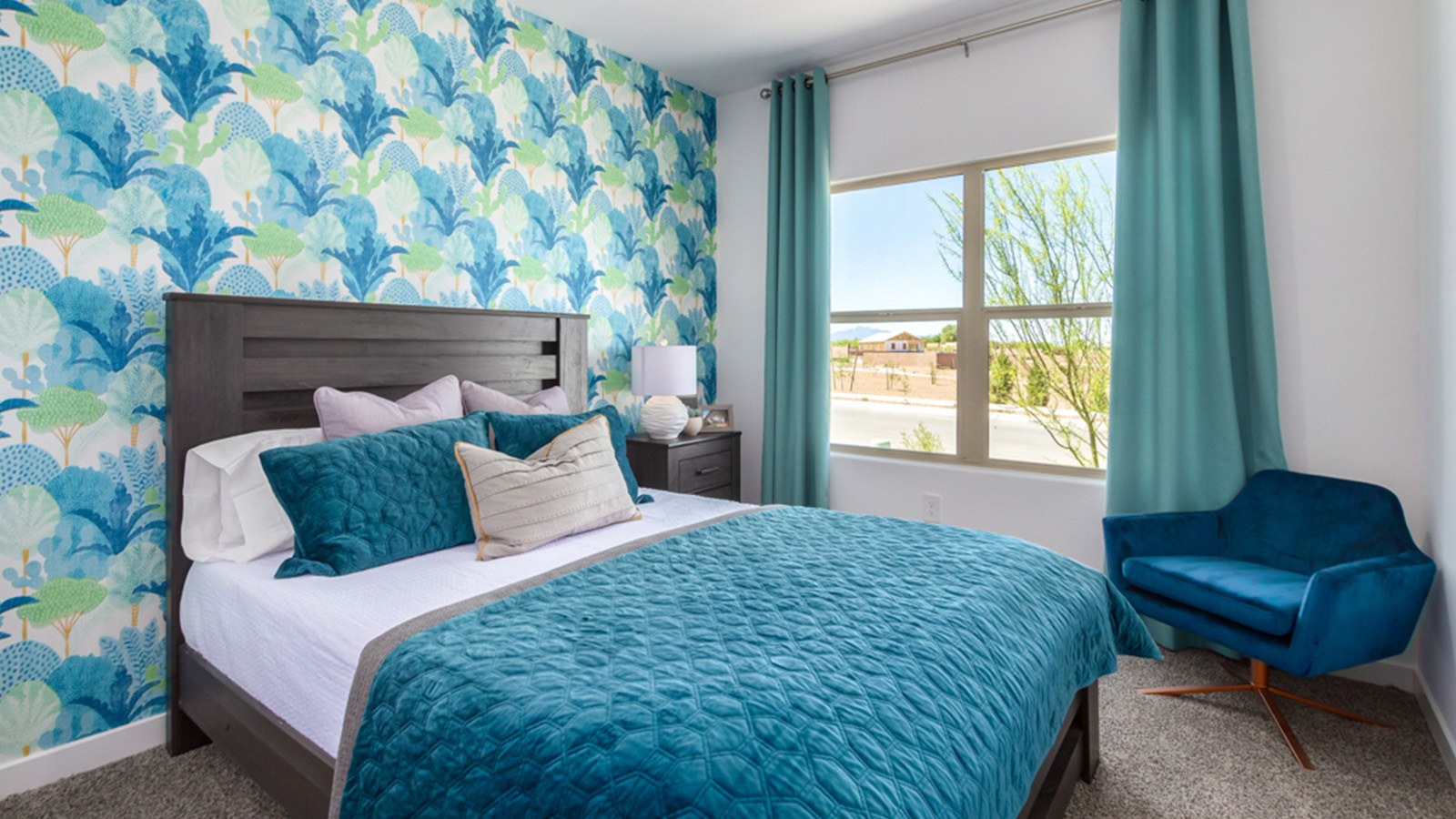 Welcome to The Gaven plan, a spacious single-story within Saguaro Bloom, where modern living meets the serene beauty of the Arizona landscape. This thoughtfully crafted layout offers 1,815 square feet of well-designed living space, featuring four bedrooms and two full bathrooms, perfect for families who value both comfort and style.  As you enter the home, you’ll be greeted by a bright and airy entryway that seamlessly transitions into the heart of the home. The open layout connects the great room, dining area, and kitchen area. The kitchen is a culinary haven, equipped with state-of-the-art appliances, a spacious pantry, and elegant quartz countertops that extend to a large island, perfect for meal prep or casual dining.  The primary suite, nestled at the rear of the home, offers a peaceful retreat with a generously sized walk-in closet and a luxurious en-suite bathroom. The additional three bedrooms are strategically placed to provide privacy and convenience, making them perfect for children, guests, or even a home office. Outside, the covered patio extends your living space, ideal for enjoying Arizona’s stunning sunsets. The front yard is fully landscaped and equipped with an auto drip irrigation system, ensuring your home’s curb appeal is maintained with ease.  Each home within Saguaro Bloom, is outfitted with D.R. Horton’s Home is Connected® Smart Home package, featuring a smart thermostat, video doorbell, keyless entry, and Wi-Fi-enabled garage door opener. Energy efficiency is a cornerstone of the design, with features like spray foam insulation, tankless water heater, and LED lighting, all contributing to long-term savings and environmental sustainability.  Saguaro Bloom is a vibrant community with a wealth of amenities, from scenic walking trails to pools and playgrounds, ensuring that there’s always something for everyone. Embrace the lifestyle you’ve always dreamed of in The Gaven — a perfect blend of comfort, convenience, and Arizona charm.  *Images shown are for reference only. They depict the Gaven Model home and may not represent the actual home.