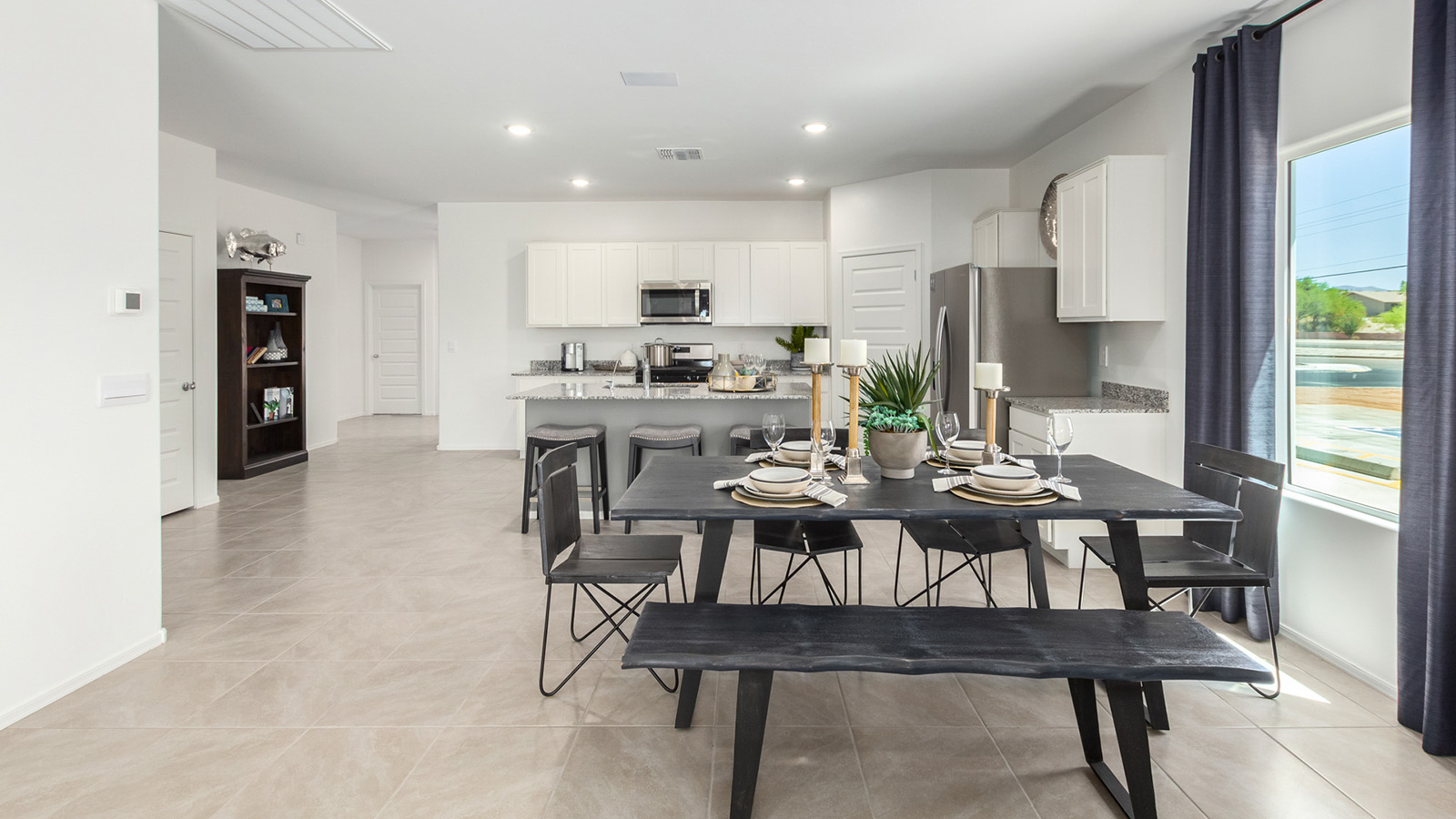 Welcome to The Gaven plan, a spacious single-story within Saguaro Bloom, where modern living meets the serene beauty of the Arizona landscape. This thoughtfully crafted layout offers 1,815 square feet of well-designed living space, featuring four bedrooms and two full bathrooms, perfect for families who value both comfort and style.  As you enter the home, you’ll be greeted by a bright and airy entryway that seamlessly transitions into the heart of the home. The open layout connects the great room, dining area, and kitchen area. The kitchen is a culinary haven, equipped with state-of-the-art appliances, a spacious pantry, and elegant quartz countertops that extend to a large island, perfect for meal prep or casual dining.  The primary suite, nestled at the rear of the home, offers a peaceful retreat with a generously sized walk-in closet and a luxurious en-suite bathroom. The additional three bedrooms are strategically placed to provide privacy and convenience, making them perfect for children, guests, or even a home office. Outside, the covered patio extends your living space, ideal for enjoying Arizona’s stunning sunsets. The front yard is fully landscaped and equipped with an auto drip irrigation system, ensuring your home’s curb appeal is maintained with ease.  Each home within Saguaro Bloom, is outfitted with D.R. Horton’s Home is Connected® Smart Home package, featuring a smart thermostat, video doorbell, keyless entry, and Wi-Fi-enabled garage door opener. Energy efficiency is a cornerstone of the design, with features like spray foam insulation, tankless water heater, and LED lighting, all contributing to long-term savings and environmental sustainability.  Saguaro Bloom is a vibrant community with a wealth of amenities, from scenic walking trails to pools and playgrounds, ensuring that there’s always something for everyone. Embrace the lifestyle you’ve always dreamed of in The Gaven — a perfect blend of comfort, convenience, and Arizona charm.  *Images shown are for reference only. They depict the Gaven model home and may not represent the actual home.