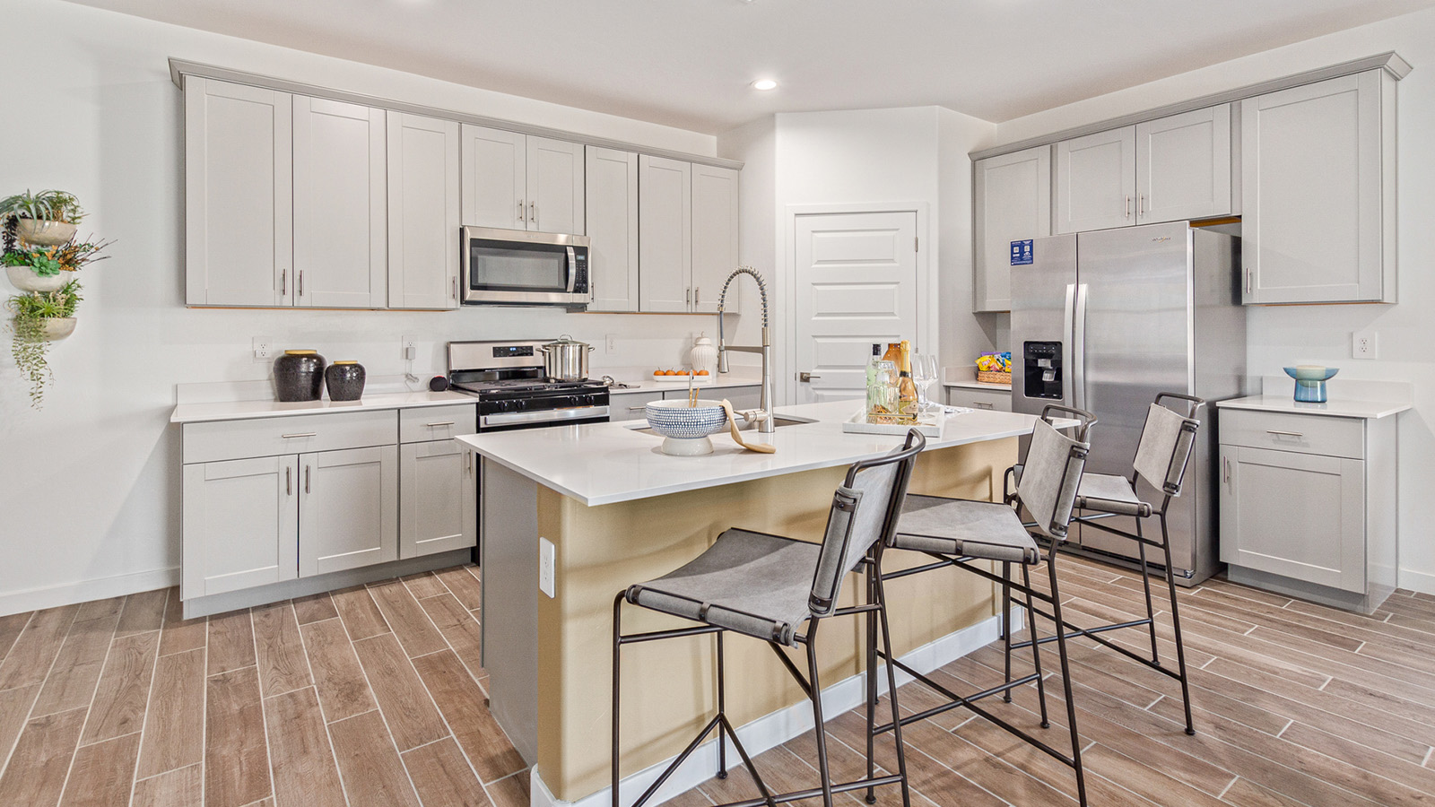 Welcome to the Gaven plan, a spacious single-story new home within Saguaro Bloom, where modern living meets the serene beauty of the Arizona landscape. This thoughtfully crafted residence offers 1,815 square feet of well-designed living space, featuring four bedrooms and two full bathrooms, perfect for families who value both comfort and style. As you step through the front door, you’ll be greeted by a bright and airy entryway that seamlessly transitions into the heart of the home. The open layout connects the great room, dining area, and kitchen, creating an ideal environment for both everyday living and entertaining. The kitchen is a culinary haven, equipped with state-of-the-art appliances, a spacious pantry, and elegant quartz countertops that extend to a large island, perfect for meal prep or casual dining.  The master suite, nestled at the rear of the home, offers a peaceful retreat with a generously sized walk-in closet and a luxurious en-suite bathroom. The additional three bedrooms are strategically placed to provide privacy and convenience, making them perfect for children, guests, or even a home office. Outside, the covered patio extends your living space into the beautifully landscaped backyard, ideal for enjoying Arizona’s stunning sunsets. The front yard is also fully landscaped and equipped with an auto drip irrigation system, ensuring your home’s curb appeal is maintained with ease.  Each home within Saguaro Bloom, including the Gaven plan, is outfitted with D.R. Horton’s Home is Connected® Smart Home package, featuring a smart thermostat, video doorbell, keyless entry, and Wi-Fi-enabled garage door opener. Energy efficiency is a cornerstone of the design, with features like spray foam insulation, tankless water heaters, and LED lighting, all contributing to long-term savings and environmental sustainability.  Saguaro Bloom isn’t just a place to live; it’s a vibrant community with a wealth of amenities, from scenic walking trails to pools and playgrounds, ensuring that there’s always something for everyone. Embrace the lifestyle you’ve always dreamed of in the Gaven plan—a perfect blend of comfort, convenience, and Arizona charm