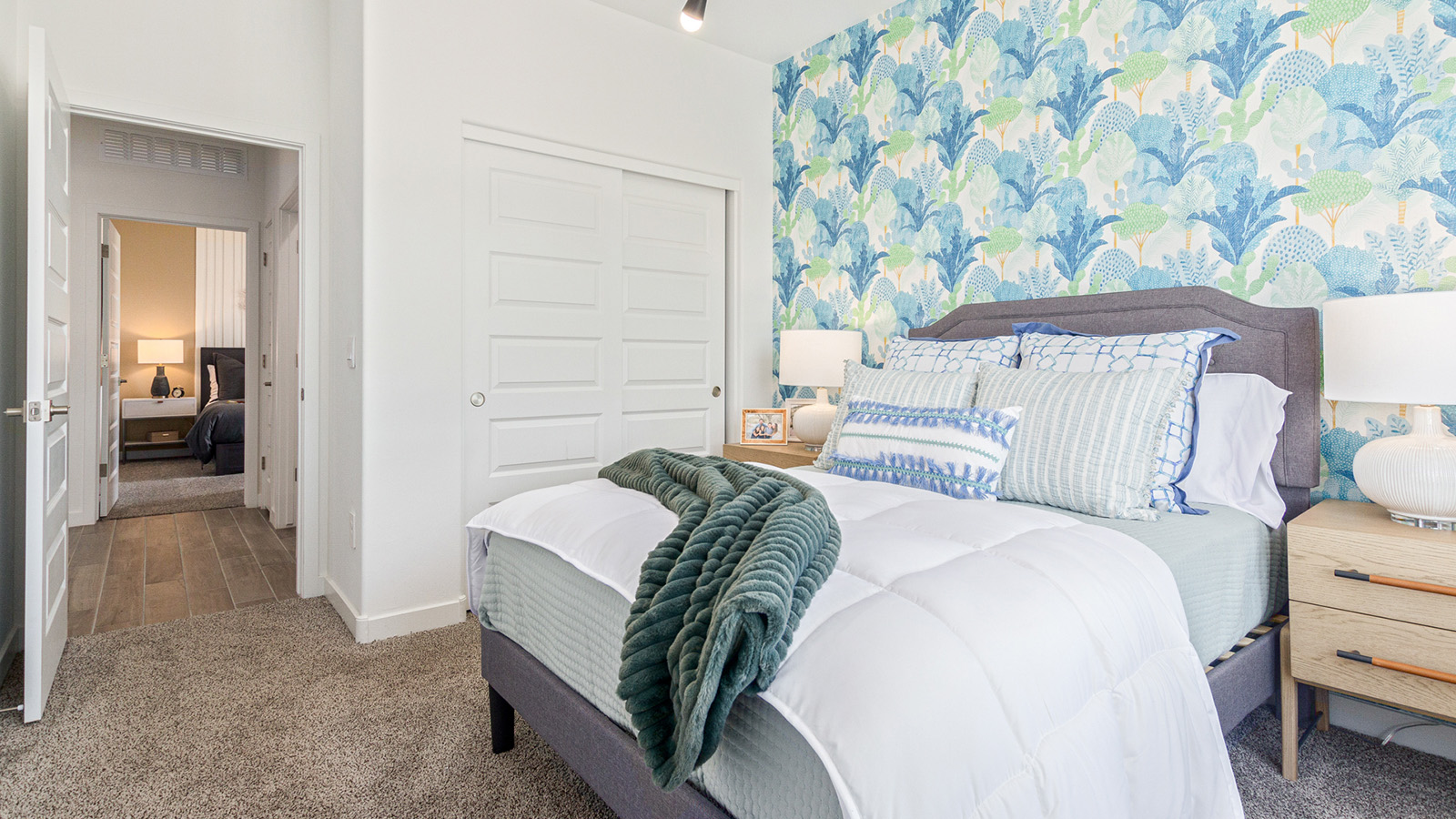 Welcome to the Gaven plan, a spacious single-story new home within Saguaro Bloom, where modern living meets the serene beauty of the Arizona landscape. This thoughtfully crafted residence offers 1,815 square feet of well-designed living space, featuring four bedrooms and two full bathrooms, perfect for families who value both comfort and style. As you step through the front door, you’ll be greeted by a bright and airy entryway that seamlessly transitions into the heart of the home. The open layout connects the great room, dining area, and kitchen, creating an ideal environment for both everyday living and entertaining. The kitchen is a culinary haven, equipped with state-of-the-art appliances, a spacious pantry, and elegant quartz countertops that extend to a large island, perfect for meal prep or casual dining.  The master suite, nestled at the rear of the home, offers a peaceful retreat with a generously sized walk-in closet and a luxurious en-suite bathroom. The additional three bedrooms are strategically placed to provide privacy and convenience, making them perfect for children, guests, or even a home office. Outside, the covered patio extends your living space into the beautifully landscaped backyard, ideal for enjoying Arizona’s stunning sunsets. The front yard is also fully landscaped and equipped with an auto drip irrigation system, ensuring your home’s curb appeal is maintained with ease.  Each home within Saguaro Bloom, including the Gaven plan, is outfitted with D.R. Horton’s Home is Connected® Smart Home package, featuring a smart thermostat, video doorbell, keyless entry, and Wi-Fi-enabled garage door opener. Energy efficiency is a cornerstone of the design, with features like spray foam insulation, tankless water heaters, and LED lighting, all contributing to long-term savings and environmental sustainability.  Saguaro Bloom isn’t just a place to live; it’s a vibrant community with a wealth of amenities, from scenic walking trails to pools and playgrounds, ensuring that there’s always something for everyone. Embrace the lifestyle you’ve always dreamed of in the Gaven plan—a perfect blend of comfort, convenience, and Arizona charm