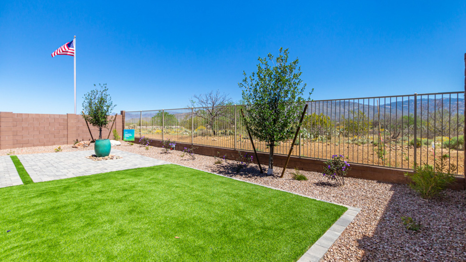 Welcome to the Gaven plan, a spacious single-story new home within Saguaro Bloom, where modern living meets the serene beauty of the Arizona landscape. This thoughtfully crafted residence offers 1,815 square feet of well-designed living space, featuring four bedrooms and two full bathrooms, perfect for families who value both comfort and style. As you step through the front door, you’ll be greeted by a bright and airy entryway that seamlessly transitions into the heart of the home. The open layout connects the great room, dining area, and kitchen, creating an ideal environment for both everyday living and entertaining. The kitchen is a culinary haven, equipped with state-of-the-art appliances, a spacious pantry, and elegant quartz countertops that extend to a large island, perfect for meal prep or casual dining.  The master suite, nestled at the rear of the home, offers a peaceful retreat with a generously sized walk-in closet and a luxurious en-suite bathroom. The additional three bedrooms are strategically placed to provide privacy and convenience, making them perfect for children, guests, or even a home office. Outside, the covered patio extends your living space into the beautifully landscaped backyard, ideal for enjoying Arizona’s stunning sunsets. The front yard is also fully landscaped and equipped with an auto drip irrigation system, ensuring your home’s curb appeal is maintained with ease.  Each home within Saguaro Bloom, including the Gaven plan, is outfitted with D.R. Horton’s Home is Connected® Smart Home package, featuring a smart thermostat, video doorbell, keyless entry, and Wi-Fi-enabled garage door opener. Energy efficiency is a cornerstone of the design, with features like spray foam insulation, tankless water heaters, and LED lighting, all contributing to long-term savings and environmental sustainability.  Saguaro Bloom isn’t just a place to live; it’s a vibrant community with a wealth of amenities, from scenic walking trails to pools and playgrounds, ensuring that there’s always something for everyone. Embrace the lifestyle you’ve always dreamed of in the Gaven plan—a perfect blend of comfort, convenience, and Arizona charm