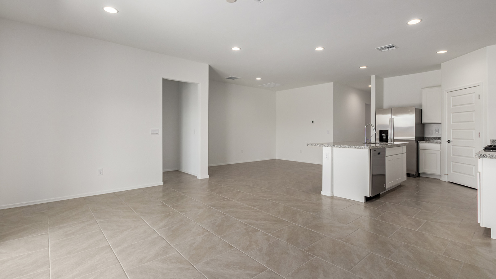 Discover The Easton at Saguaro Bloom in Marana, Arizona – a spacious 1,697 sq. ft. single-story new home designed to offer both style and functionality for today’s modern family.  As you enter through the front porch, you’re welcomed into a thoughtful layout that makes every square foot count. Near the front entrance is the first bedroom intentionally situated. This room can be utilized as a guest room, home office, or a cozy retreat.  Continuing down the hall you're welcomed into the great room, which flows seamlessly into the dining area and kitchen. This open-concept design ensures that the heart of the home is always connected. The kitchen is a culinary dream, featuring quartz countertops, a spacious island with a breakfast bar, and a walk-in pantry.  The great room opens up to a covered patio, an ideal space to unwind and enjoy beautiful desert sunsets. Whether you’re hosting a weekend barbecue or enjoying a quiet evening outdoors, this patio extends your living space into the scenic surroundings of Saguaro Bloom.  Just off the great room, a private hallway leads to the primary suite. The primary suite is generously sized and features a large walk-in closet, en-suite bathroom with walk-in shower, offering both privacy and convenience.  The Easton also features two additional bedrooms, well-positioned to share a full bathroom. These rooms are ideal for family members.  The Easton is designed with energy efficiency in mind and is DOE Zero Energy Ready Home Certified. This home includes a Connected® Smart Home package, featuring a smart thermostat, video doorbell, keyless entry, and Wi-Fi-enabled garage door opener. Energy efficiency is a cornerstone of the design, with features like spray foam insulation, and tankless water heater, offering long-term savings and sustainability.  Saguaro Bloom isn’t just a place to live, it’s a vibrant community with a wealth of amenities, from scenic walking trails to pools and playgrounds, ensuring that there’s always something for everyone.