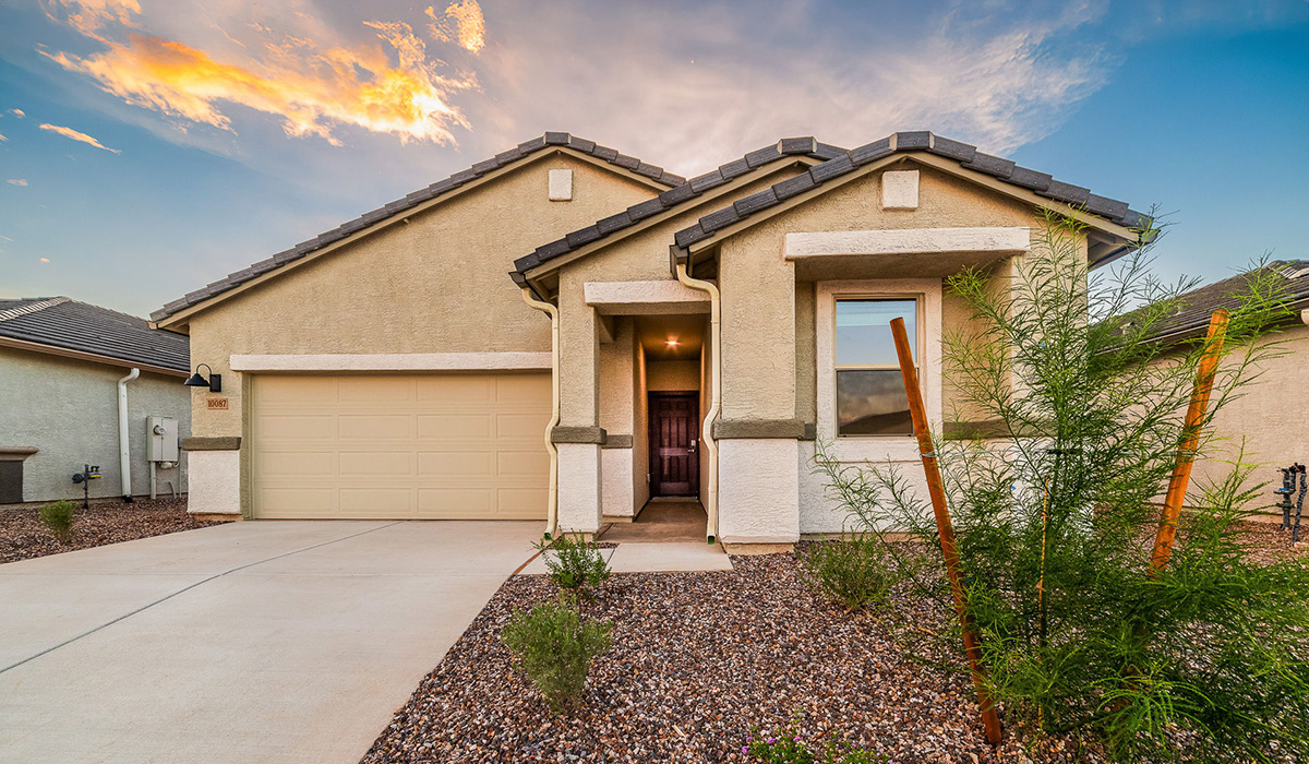Discover The Easton at Saguaro Bloom in Marana, Arizona – a spacious 1,697 sq. ft. single-story new home designed to offer both style and functionality for today’s modern family.  As you enter through the front porch, you’re welcomed into a thoughtful layout that makes every square foot count. Near the front entrance is the first bedroom intentionally situated. This room can be utilized as a guest room, home office, or a cozy retreat.  Continuing down the hall you're welcomed into the great room, which flows seamlessly into the dining area and kitchen. This open-concept design ensures that the heart of the home is always connected. The kitchen is a culinary dream, featuring quartz countertops, a spacious island with a breakfast bar, and a walk-in pantry.  The great room opens up to a covered patio, an ideal space to unwind and enjoy beautiful desert sunsets. Whether you’re hosting a weekend barbecue or enjoying a quiet evening outdoors, this patio extends your living space into the scenic surroundings of Saguaro Bloom.  Just off the great room, a private hallway leads to the primary suite. The primary suite is generously sized and features a large walk-in closet, en-suite bathroom with walk-in shower, offering both privacy and convenience.  The Easton also features two additional bedrooms, well-positioned to share a full bathroom. These rooms are ideal for family members.  The Easton is designed with energy efficiency in mind and is DOE Zero Energy Ready Home Certified. This home includes a Connected® Smart Home package, featuring a smart thermostat, video doorbell, keyless entry, and Wi-Fi-enabled garage door opener. Energy efficiency is a cornerstone of the design, with features like spray foam insulation, and tankless water heater, offering long-term savings and sustainability.  Saguaro Bloom isn’t just a place to live, it’s a vibrant community with a wealth of amenities, from scenic walking trails to pools and playgrounds, ensuring that there’s always something for everyone.