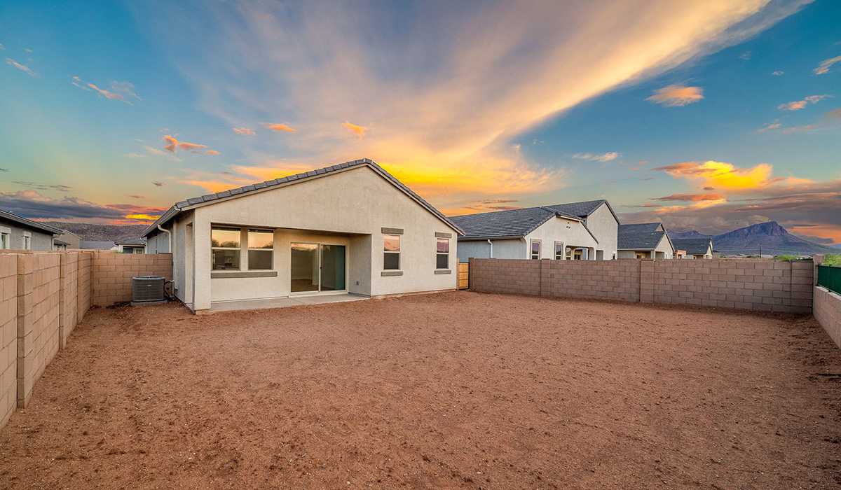 Discover The Easton at Saguaro Bloom in Marana, Arizona – a spacious 1,697 sq. ft. single-story new home designed to offer both style and functionality for today’s modern family.  As you enter through the front porch, you’re welcomed into a thoughtful layout that makes every square foot count. Near the front entrance is the first bedroom intentionally situated. This room can be utilized as a guest room, home office, or a cozy retreat.  Continuing down the hall you're welcomed into the great room, which flows seamlessly into the dining area and kitchen. This open-concept design ensures that the heart of the home is always connected. The kitchen is a culinary dream, featuring quartz countertops, a spacious island with a breakfast bar, and a walk-in pantry.  The great room opens up to a covered patio, an ideal space to unwind and enjoy beautiful desert sunsets. Whether you’re hosting a weekend barbecue or enjoying a quiet evening outdoors, this patio extends your living space into the scenic surroundings of Saguaro Bloom.  Just off the great room, a private hallway leads to the primary suite. The primary suite is generously sized and features a large walk-in closet, en-suite bathroom with walk-in shower, offering both privacy and convenience.  The Easton also features two additional bedrooms, well-positioned to share a full bathroom. These rooms are ideal for family members.  The Easton is designed with energy efficiency in mind and is DOE Zero Energy Ready Home Certified. This home includes a Connected® Smart Home package, featuring a smart thermostat, video doorbell, keyless entry, and Wi-Fi-enabled garage door opener. Energy efficiency is a cornerstone of the design, with features like spray foam insulation, and tankless water heater, offering long-term savings and sustainability.  Saguaro Bloom isn’t just a place to live, it’s a vibrant community with a wealth of amenities, from scenic walking trails to pools and playgrounds, ensuring that there’s always something for everyone.