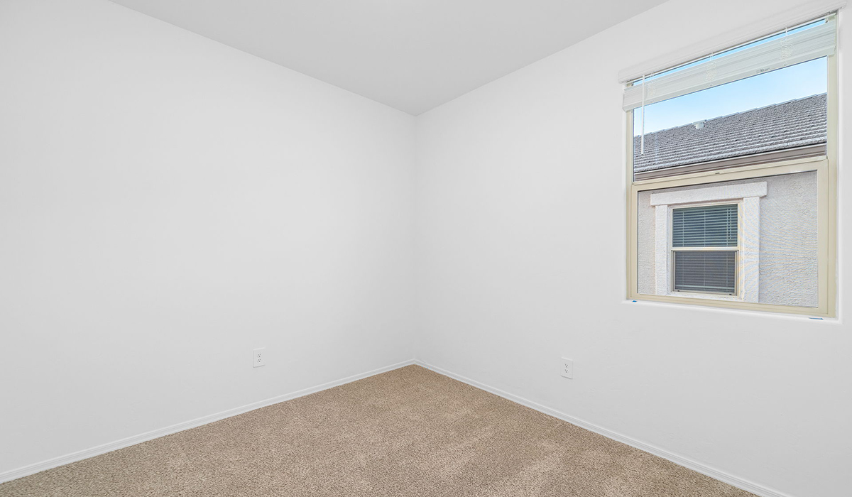 Discover The Easton at Saguaro Bloom in Marana, Arizona – a spacious 1,697 sq. ft. single-story new home designed to offer both style and functionality for today’s modern family.  As you enter through the front porch, you’re welcomed into a thoughtful layout that makes every square foot count. Near the front entrance is the first bedroom intentionally situated. This room can be utilized as a guest room, home office, or a cozy retreat.  Continuing down the hall you're welcomed into the great room, which flows seamlessly into the dining area and kitchen. This open-concept design ensures that the heart of the home is always connected. The kitchen is a culinary dream, featuring quartz countertops, a spacious island with a breakfast bar, and a walk-in pantry.  The great room opens up to a covered patio, an ideal space to unwind and enjoy beautiful desert sunsets. Whether you’re hosting a weekend barbecue or enjoying a quiet evening outdoors, this patio extends your living space into the scenic surroundings of Saguaro Bloom.  Just off the great room, a private hallway leads to the primary suite. The primary suite is generously sized and features a large walk-in closet, en-suite bathroom with walk-in shower, offering both privacy and convenience.  The Easton also features two additional bedrooms, well-positioned to share a full bathroom. These rooms are ideal for family members.  The Easton is designed with energy efficiency in mind and is DOE Zero Energy Ready Home Certified. This home includes a Connected® Smart Home package, featuring a smart thermostat, video doorbell, keyless entry, and Wi-Fi-enabled garage door opener. Energy efficiency is a cornerstone of the design, with features like spray foam insulation, and tankless water heater, offering long-term savings and sustainability.  Saguaro Bloom isn’t just a place to live, it’s a vibrant community with a wealth of amenities, from scenic walking trails to pools and playgrounds, ensuring that there’s always something for everyone.