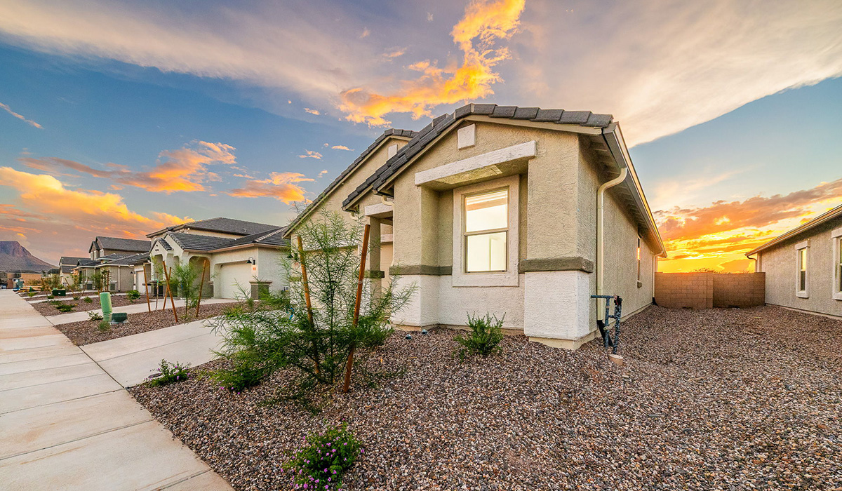 Discover The Easton at Saguaro Bloom in Marana, Arizona – a spacious 1,697 sq. ft. single-story new home designed to offer both style and functionality for today’s modern family.  As you enter through the front porch, you’re welcomed into a thoughtful layout that makes every square foot count. Near the front entrance is the first bedroom intentionally situated. This room can be utilized as a guest room, home office, or a cozy retreat.  Continuing down the hall you're welcomed into the great room, which flows seamlessly into the dining area and kitchen. This open-concept design ensures that the heart of the home is always connected. The kitchen is a culinary dream, featuring quartz countertops, a spacious island with a breakfast bar, and a walk-in pantry.  The great room opens up to a covered patio, an ideal space to unwind and enjoy beautiful desert sunsets. Whether you’re hosting a weekend barbecue or enjoying a quiet evening outdoors, this patio extends your living space into the scenic surroundings of Saguaro Bloom.  Just off the great room, a private hallway leads to the primary suite. The primary suite is generously sized and features a large walk-in closet, en-suite bathroom with walk-in shower, offering both privacy and convenience.  The Easton also features two additional bedrooms, well-positioned to share a full bathroom. These rooms are ideal for family members.  The Easton is designed with energy efficiency in mind and is DOE Zero Energy Ready Home Certified. This home includes a Connected® Smart Home package, featuring a smart thermostat, video doorbell, keyless entry, and Wi-Fi-enabled garage door opener. Energy efficiency is a cornerstone of the design, with features like spray foam insulation, and tankless water heater, offering long-term savings and sustainability.  Saguaro Bloom isn’t just a place to live, it’s a vibrant community with a wealth of amenities, from scenic walking trails to pools and playgrounds, ensuring that there’s always something for everyone.  *Images shown are for reference only. They depict The Easton spec home and may not represent the actual home.