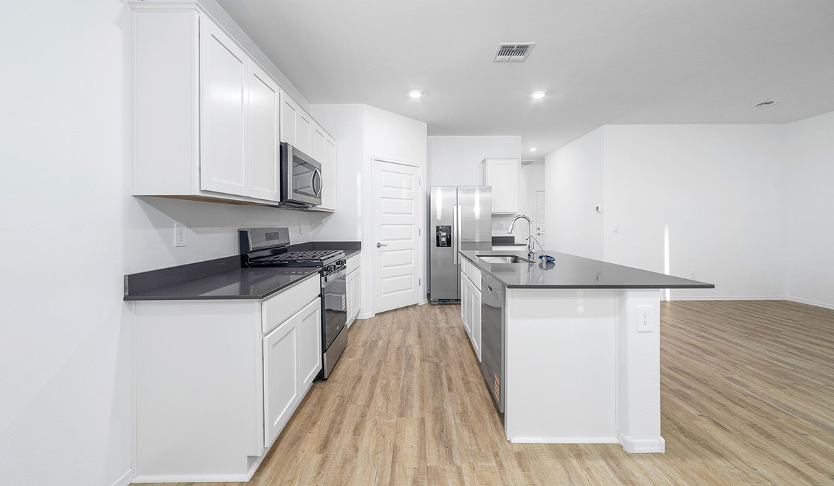 Discover The Easton at Saguaro Bloom in Marana, Arizona – a spacious 1,697 sq. ft. single-story new home designed to offer both style and functionality for today’s modern family.  As you enter through the front porch, you’re welcomed into a thoughtful layout that makes every square foot count. Near the front entrance is the first bedroom intentionally situated. This room can be utilized as a guest room, home office, or a cozy retreat.  Continuing down the hall you're welcomed into the great room, which flows seamlessly into the dining area and kitchen. This open-concept design ensures that the heart of the home is always connected. The kitchen is a culinary dream, featuring quartz countertops, a spacious island with a breakfast bar, and a walk-in pantry.  The great room opens up to a covered patio, an ideal space to unwind and enjoy beautiful desert sunsets. Whether you’re hosting a weekend barbecue or enjoying a quiet evening outdoors, this patio extends your living space into the scenic surroundings of Saguaro Bloom.  Just off the great room, a private hallway leads to the primary suite. The primary suite is generously sized and features a large walk-in closet, en-suite bathroom with walk-in shower, offering both privacy and convenience.  The Easton also features two additional bedrooms, well-positioned to share a full bathroom. These rooms are ideal for family members.  The Easton is designed with energy efficiency in mind and is DOE Zero Energy Ready Home Certified. This home includes a Connected® Smart Home package, featuring a smart thermostat, video doorbell, keyless entry, and Wi-Fi-enabled garage door opener. Energy efficiency is a cornerstone of the design, with features like spray foam insulation, and tankless water heater, offering long-term savings and sustainability.  Saguaro Bloom isn’t just a place to live, it’s a vibrant community with a wealth of amenities, from scenic walking trails to pools and playgrounds, ensuring that there’s always something for everyone.