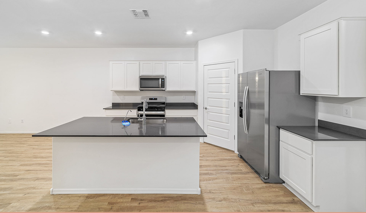 Discover The Easton at Saguaro Bloom in Marana, Arizona – a spacious 1,697 sq. ft. single-story new home designed to offer both style and functionality for today’s modern family.  As you enter through the front porch, you’re welcomed into a thoughtful layout that makes every square foot count. Near the front entrance is the first bedroom intentionally situated. This room can be utilized as a guest room, home office, or a cozy retreat.  Continuing down the hall you're welcomed into the great room, which flows seamlessly into the dining area and kitchen. This open-concept design ensures that the heart of the home is always connected. The kitchen is a culinary dream, featuring quartz countertops, a spacious island with a breakfast bar, and a walk-in pantry.  The great room opens up to a covered patio, an ideal space to unwind and enjoy beautiful desert sunsets. Whether you’re hosting a weekend barbecue or enjoying a quiet evening outdoors, this patio extends your living space into the scenic surroundings of Saguaro Bloom.  Just off the great room, a private hallway leads to the primary suite. The primary suite is generously sized and features a large walk-in closet, en-suite bathroom with walk-in shower, offering both privacy and convenience.  The Easton also features two additional bedrooms, well-positioned to share a full bathroom. These rooms are ideal for family members.  The Easton is designed with energy efficiency in mind and is DOE Zero Energy Ready Home Certified. This home includes a Connected® Smart Home package, featuring a smart thermostat, video doorbell, keyless entry, and Wi-Fi-enabled garage door opener. Energy efficiency is a cornerstone of the design, with features like spray foam insulation, and tankless water heater, offering long-term savings and sustainability.  Saguaro Bloom isn’t just a place to live, it’s a vibrant community with a wealth of amenities, from scenic walking trails to pools and playgrounds, ensuring that there’s always something for everyone.