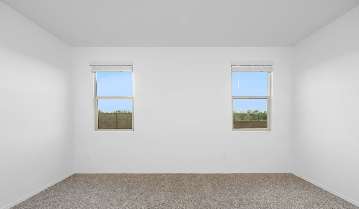 Discover The Easton at Saguaro Bloom in Marana, Arizona – a spacious 1,697 sq. ft. single-story new home designed to offer both style and functionality for today’s modern family.  As you enter through the front porch, you’re welcomed into a thoughtful layout that makes every square foot count. Near the front entrance is the first bedroom intentionally situated. This room can be utilized as a guest room, home office, or a cozy retreat.  Continuing down the hall you're welcomed into the great room, which flows seamlessly into the dining area and kitchen. This open-concept design ensures that the heart of the home is always connected. The kitchen is a culinary dream, featuring quartz countertops, a spacious island with a breakfast bar, and a walk-in pantry.  The great room opens up to a covered patio, an ideal space to unwind and enjoy beautiful desert sunsets. Whether you’re hosting a weekend barbecue or enjoying a quiet evening outdoors, this patio extends your living space into the scenic surroundings of Saguaro Bloom.  Just off the great room, a private hallway leads to the primary suite. The primary suite is generously sized and features a large walk-in closet, en-suite bathroom with walk-in shower, offering both privacy and convenience.  The Easton also features two additional bedrooms, well-positioned to share a full bathroom. These rooms are ideal for family members.  The Easton is designed with energy efficiency in mind and is DOE Zero Energy Ready Home Certified. This home includes a Connected® Smart Home package, featuring a smart thermostat, video doorbell, keyless entry, and Wi-Fi-enabled garage door opener. Energy efficiency is a cornerstone of the design, with features like spray foam insulation, and tankless water heater, offering long-term savings and sustainability.  Saguaro Bloom isn’t just a place to live, it’s a vibrant community with a wealth of amenities, from scenic walking trails to pools and playgrounds, ensuring that there’s always something for everyone.