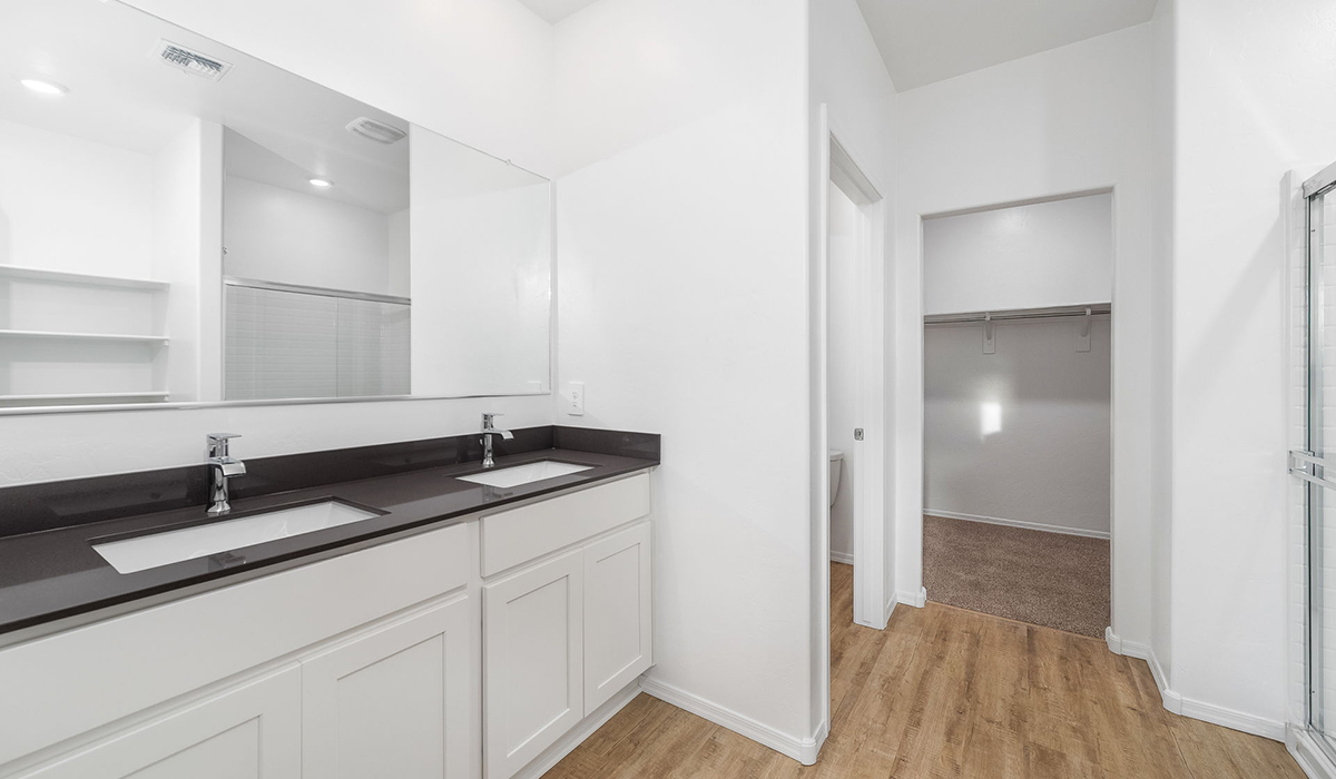 Discover The Easton at Saguaro Bloom in Marana, Arizona – a spacious 1,697 sq. ft. single-story new home designed to offer both style and functionality for today’s modern family.  As you enter through the front porch, you’re welcomed into a thoughtful layout that makes every square foot count. Near the front entrance is the first bedroom intentionally situated. This room can be utilized as a guest room, home office, or a cozy retreat.  Continuing down the hall you're welcomed into the great room, which flows seamlessly into the dining area and kitchen. This open-concept design ensures that the heart of the home is always connected. The kitchen is a culinary dream, featuring quartz countertops, a spacious island with a breakfast bar, and a walk-in pantry.  The great room opens up to a covered patio, an ideal space to unwind and enjoy beautiful desert sunsets. Whether you’re hosting a weekend barbecue or enjoying a quiet evening outdoors, this patio extends your living space into the scenic surroundings of Saguaro Bloom.  Just off the great room, a private hallway leads to the primary suite. The primary suite is generously sized and features a large walk-in closet, en-suite bathroom with walk-in shower, offering both privacy and convenience.  The Easton also features two additional bedrooms, well-positioned to share a full bathroom. These rooms are ideal for family members.  The Easton is designed with energy efficiency in mind and is DOE Zero Energy Ready Home Certified. This home includes a Connected® Smart Home package, featuring a smart thermostat, video doorbell, keyless entry, and Wi-Fi-enabled garage door opener. Energy efficiency is a cornerstone of the design, with features like spray foam insulation, and tankless water heater, offering long-term savings and sustainability.  Saguaro Bloom isn’t just a place to live, it’s a vibrant community with a wealth of amenities, from scenic walking trails to pools and playgrounds, ensuring that there’s always something for everyone.