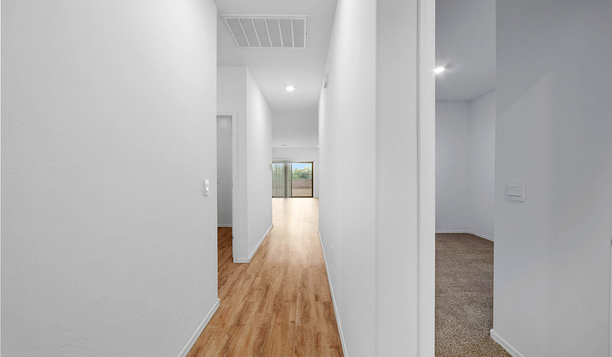 Discover The Easton at Saguaro Bloom in Marana, Arizona – a spacious 1,697 sq. ft. single-story new home designed to offer both style and functionality for today’s modern family.  As you enter through the front porch, you’re welcomed into a thoughtful layout that makes every square foot count. Near the front entrance is the first bedroom intentionally situated. This room can be utilized as a guest room, home office, or a cozy retreat.  Continuing down the hall you're welcomed into the great room, which flows seamlessly into the dining area and kitchen. This open-concept design ensures that the heart of the home is always connected. The kitchen is a culinary dream, featuring quartz countertops, a spacious island with a breakfast bar, and a walk-in pantry.  The great room opens up to a covered patio, an ideal space to unwind and enjoy beautiful desert sunsets. Whether you’re hosting a weekend barbecue or enjoying a quiet evening outdoors, this patio extends your living space into the scenic surroundings of Saguaro Bloom.  Just off the great room, a private hallway leads to the primary suite. The primary suite is generously sized and features a large walk-in closet, en-suite bathroom with walk-in shower, offering both privacy and convenience.  The Easton also features two additional bedrooms, well-positioned to share a full bathroom. These rooms are ideal for family members.  The Easton is designed with energy efficiency in mind and is DOE Zero Energy Ready Home Certified. This home includes a Connected® Smart Home package, featuring a smart thermostat, video doorbell, keyless entry, and Wi-Fi-enabled garage door opener. Energy efficiency is a cornerstone of the design, with features like spray foam insulation, and tankless water heater, offering long-term savings and sustainability.  Saguaro Bloom isn’t just a place to live, it’s a vibrant community with a wealth of amenities, from scenic walking trails to pools and playgrounds, ensuring that there’s always something for everyone.