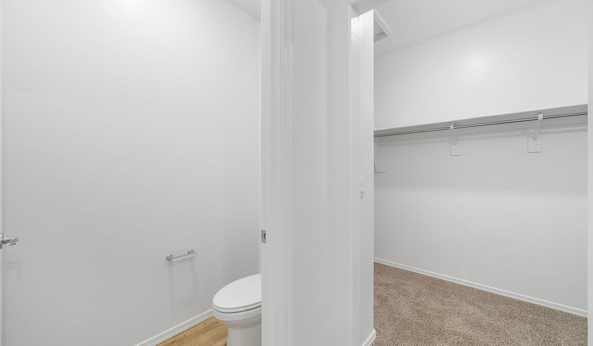 Discover The Easton at Saguaro Bloom in Marana, Arizona – a spacious 1,697 sq. ft. single-story new home designed to offer both style and functionality for today’s modern family.  As you enter through the front porch, you’re welcomed into a thoughtful layout that makes every square foot count. Near the front entrance is the first bedroom intentionally situated. This room can be utilized as a guest room, home office, or a cozy retreat.  Continuing down the hall you're welcomed into the great room, which flows seamlessly into the dining area and kitchen. This open-concept design ensures that the heart of the home is always connected. The kitchen is a culinary dream, featuring quartz countertops, a spacious island with a breakfast bar, and a walk-in pantry.  The great room opens up to a covered patio, an ideal space to unwind and enjoy beautiful desert sunsets. Whether you’re hosting a weekend barbecue or enjoying a quiet evening outdoors, this patio extends your living space into the scenic surroundings of Saguaro Bloom.  Just off the great room, a private hallway leads to the primary suite. The primary suite is generously sized and features a large walk-in closet, en-suite bathroom with walk-in shower, offering both privacy and convenience.  The Easton also features two additional bedrooms, well-positioned to share a full bathroom. These rooms are ideal for family members.  The Easton is designed with energy efficiency in mind and is DOE Zero Energy Ready Home Certified. This home includes a Connected® Smart Home package, featuring a smart thermostat, video doorbell, keyless entry, and Wi-Fi-enabled garage door opener. Energy efficiency is a cornerstone of the design, with features like spray foam insulation, and tankless water heater, offering long-term savings and sustainability.  Saguaro Bloom isn’t just a place to live, it’s a vibrant community with a wealth of amenities, from scenic walking trails to pools and playgrounds, ensuring that there’s always something for everyone.