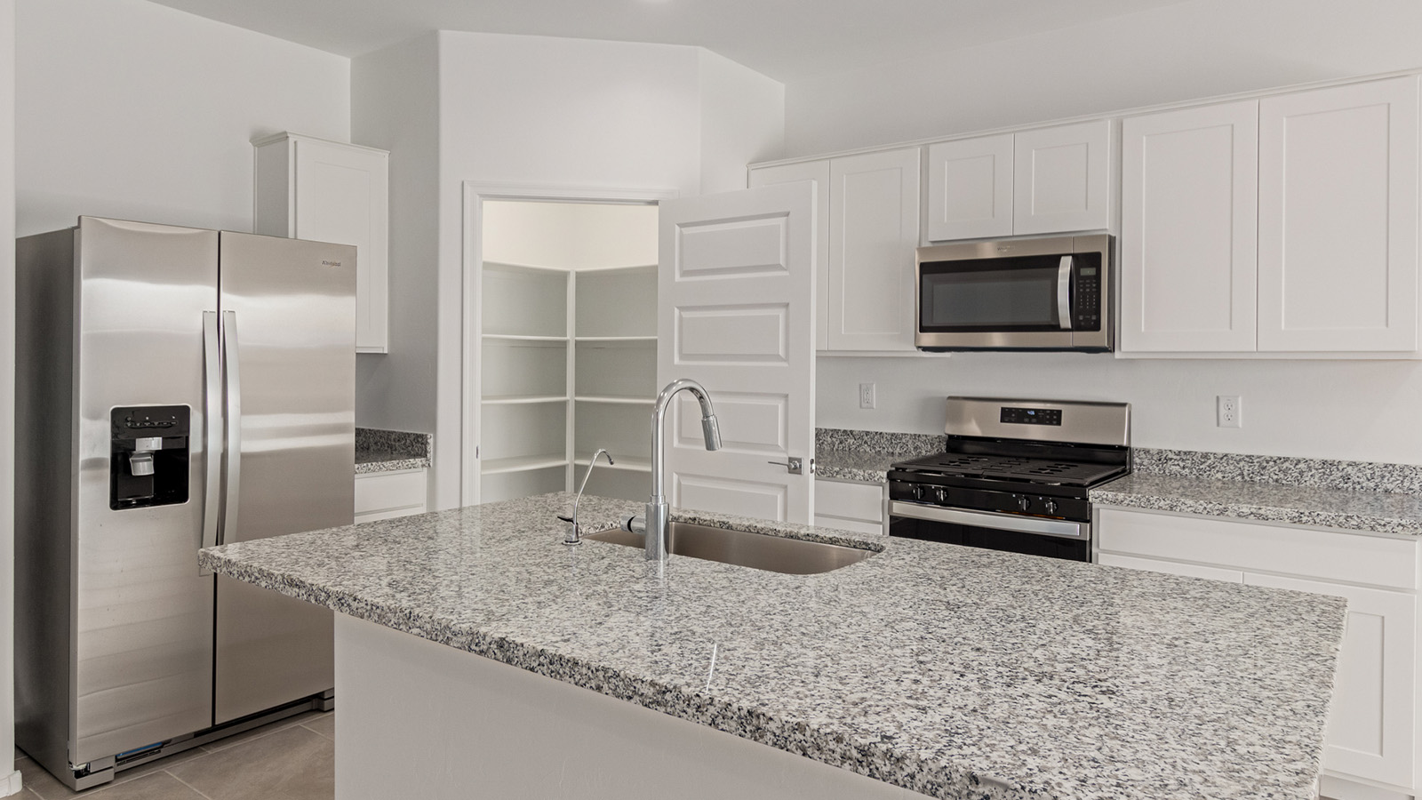 Discover The Easton at Saguaro Bloom in Marana, Arizona – a spacious 1,697 sq. ft. single-story new home designed to offer both style and functionality for today’s modern family.  As you enter through the front porch, you’re welcomed into a thoughtful layout that makes every square foot count. Near the front entrance is the first bedroom intentionally situated. This room can be utilized as a guest room, home office, or a cozy retreat.  Continuing down the hall you're welcomed into the great room, which flows seamlessly into the dining area and kitchen. This open-concept design ensures that the heart of the home is always connected. The kitchen is a culinary dream, featuring quartz countertops, a spacious island with a breakfast bar, and a walk-in pantry.  The great room opens up to a covered patio, an ideal space to unwind and enjoy beautiful desert sunsets. Whether you’re hosting a weekend barbecue or enjoying a quiet evening outdoors, this patio extends your living space into the scenic surroundings of Saguaro Bloom.  Just off the great room, a private hallway leads to the primary suite. The primary suite is generously sized and features a large walk-in closet, en-suite bathroom with walk-in shower, offering both privacy and convenience.  The Easton also features two additional bedrooms, well-positioned to share a full bathroom. These rooms are ideal for family members.  The Easton is designed with energy efficiency in mind and is DOE Zero Energy Ready Home Certified. This home includes a Connected® Smart Home package, featuring a smart thermostat, video doorbell, keyless entry, and Wi-Fi-enabled garage door opener. Energy efficiency is a cornerstone of the design, with features like spray foam insulation, and tankless water heater, offering long-term savings and sustainability.  Saguaro Bloom isn’t just a place to live, it’s a vibrant community with a wealth of amenities, from scenic walking trails to pools and playgrounds, ensuring that there’s always something for everyone.