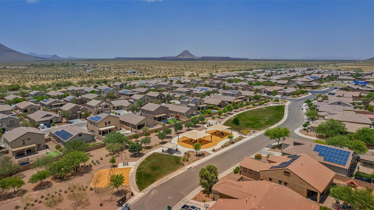 Welcome to The Pearl, a beautifully designed single-story new home located in the serene Cholla Ridge neighborhood of Saguaro Bloom. Spanning 2,431 square feet, this home offers four spacious bedrooms and three full bathrooms, making it an ideal choice for families who value both space and comfort.  As you enter through the front porch, you’re welcomed into a bright and open entryway that leads to the heart of the home. The expansive great room, dining area, and kitchen are seamlessly connected, providing a perfect setting for both everyday living and entertaining. The kitchen is a chef’s delight, featuring a large island, granite countertops, and Shaker-style cabinetry in double espresso. With a generously sized pantry and modern stainless steel gas appliances, this kitchen is both functional and stylish.  The Pearl’s layout includes a well-placed primary bedroom at the rear of the home, ensuring privacy and tranquility. The primary suite features a spacious walk-in closet and an en-suite bathroom with dual executive-height vanities and a large walk-in shower. The additional three bedrooms are located towards the front and sides of the home, each offering ample closet space and access to two full bathrooms, making this layout perfect for families and guests alike.  The outdoor living space is just as inviting, with a covered patio that extends from the great room, providing an ideal spot for enjoying Arizona’s beautiful weather. Whether you’re hosting a gathering or simply relaxing with a good book, this space is designed for your enjoyment.  The Pearl also features a dedicated utility room near the kitchen, making household tasks more convenient. A two-car garage offers plenty of space for vehicles and additional storage.  Built with energy efficiency and modern living in mind, The Pearl incorporates eco-friendly features and smart home technology, ensuring a comfortable and sustainable lifestyle. Large windows throughout the home allow natural light to flood the space, creating a warm and inviting atmosphere.  Located within the exclusive Cholla Ridge neighborhood at Saguaro Bloom, residents of The Pearl enjoy a range of amenities, including beautiful 12x24” tile flooring, and gourmet kitchens in select homes, all on lots with no rear neighbors. The community offers access to two pools, walking trails, and parks, all set against the stunning backdrop of the Tucson Mountains.  The Pearl combines style, comfort, and practicality, making it a perfect place to call home in one of Marana’s most sought-after communities.