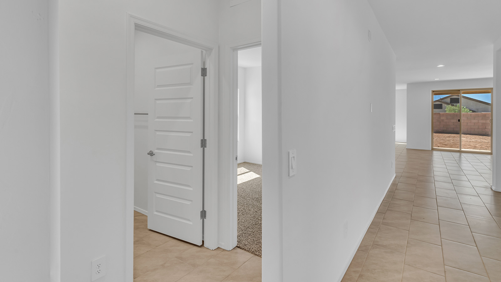 Welcome to The Pearl, a beautifully designed single-story new home located in the serene Cholla Ridge neighborhood of Saguaro Bloom. Spanning 2,431 square feet, this home offers four spacious bedrooms and three full bathrooms, making it an ideal choice for families who value both space and comfort.  As you enter through the front porch, you’re welcomed into a bright and open entryway that leads to the heart of the home. The expansive great room, dining area, and kitchen are seamlessly connected, providing a perfect setting for both everyday living and entertaining. The kitchen is a chef’s delight, featuring a large island, granite countertops, and Shaker-style cabinetry in double espresso. With a generously sized pantry and modern stainless steel gas appliances, this kitchen is both functional and stylish.  The Pearl’s layout includes a well-placed primary bedroom at the rear of the home, ensuring privacy and tranquility. The primary suite features a spacious walk-in closet and an en-suite bathroom with dual executive-height vanities and a large walk-in shower. The additional three bedrooms are located towards the front and sides of the home, each offering ample closet space and access to two full bathrooms, making this layout perfect for families and guests alike.  The outdoor living space is just as inviting, with a covered patio that extends from the great room, providing an ideal spot for enjoying Arizona’s beautiful weather. Whether you’re hosting a gathering or simply relaxing with a good book, this space is designed for your enjoyment.  The Pearl also features a dedicated utility room near the kitchen, making household tasks more convenient. A two-car garage offers plenty of space for vehicles and additional storage.  Built with energy efficiency and modern living in mind, The Pearl incorporates eco-friendly features and smart home technology, ensuring a comfortable and sustainable lifestyle. Large windows throughout the home allow natural light to flood the space, creating a warm and inviting atmosphere.  Located within the exclusive Cholla Ridge neighborhood at Saguaro Bloom, residents of The Pearl enjoy a range of amenities, including beautiful 12x24” tile flooring, and gourmet kitchens in select homes, all on lots with no rear neighbors. The community offers access to two pools, walking trails, and parks, all set against the stunning backdrop of the Tucson Mountains.  The Pearl combines style, comfort, and practicality, making it a perfect place to call home in one of Marana’s most sought-after communities.