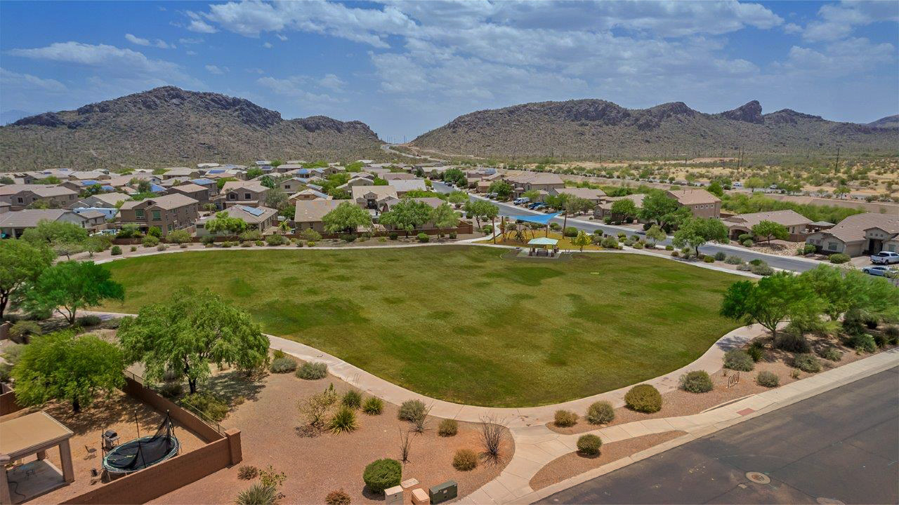 Welcome to The Pearl, a beautifully designed single-story new home located in the serene Cholla Ridge neighborhood of Saguaro Bloom. Spanning 2,431 square feet, this home offers four spacious bedrooms and three full bathrooms, making it an ideal choice for families who value both space and comfort.  As you enter through the front porch, you’re welcomed into a bright and open entryway that leads to the heart of the home. The expansive great room, dining area, and kitchen are seamlessly connected, providing a perfect setting for both everyday living and entertaining. The kitchen is a chef’s delight, featuring a large island, granite countertops, and Shaker-style cabinetry in double espresso. With a generously sized pantry and modern stainless steel gas appliances, this kitchen is both functional and stylish.  The Pearl’s layout includes a well-placed primary bedroom at the rear of the home, ensuring privacy and tranquility. The primary suite features a spacious walk-in closet and an en-suite bathroom with dual executive-height vanities and a large walk-in shower. The additional three bedrooms are located towards the front and sides of the home, each offering ample closet space and access to two full bathrooms, making this layout perfect for families and guests alike.  The outdoor living space is just as inviting, with a covered patio that extends from the great room, providing an ideal spot for enjoying Arizona’s beautiful weather. Whether you’re hosting a gathering or simply relaxing with a good book, this space is designed for your enjoyment.  The Pearl also features a dedicated utility room near the kitchen, making household tasks more convenient. A two-car garage offers plenty of space for vehicles and additional storage.  Built with energy efficiency and modern living in mind, The Pearl incorporates eco-friendly features and smart home technology, ensuring a comfortable and sustainable lifestyle. Large windows throughout the home allow natural light to flood the space, creating a warm and inviting atmosphere.  Located within the exclusive Cholla Ridge neighborhood at Saguaro Bloom, residents of The Pearl enjoy a range of amenities, including beautiful 12x24” tile flooring, and gourmet kitchens in select homes, all on lots with no rear neighbors. The community offers access to two pools, walking trails, and parks, all set against the stunning backdrop of the Tucson Mountains.  The Pearl combines style, comfort, and practicality, making it a perfect place to call home in one of Marana’s most sought-after communities.