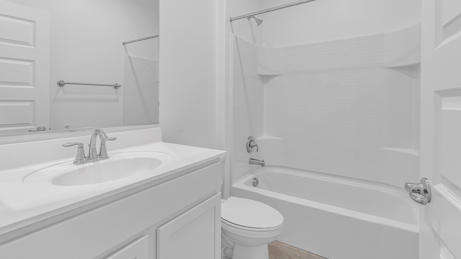 Welcome to The Pearl, a beautifully designed single-story new home located in the serene Cholla Ridge neighborhood of Saguaro Bloom. Spanning 2,431 square feet, this home offers four spacious bedrooms and three full bathrooms, making it an ideal choice for families who value both space and comfort.  As you enter through the front porch, you’re welcomed into a bright and open entryway that leads to the heart of the home. The expansive great room, dining area, and kitchen are seamlessly connected, providing a perfect setting for both everyday living and entertaining. The kitchen is a chef’s delight, featuring a large island, granite countertops, and Shaker-style cabinetry in double espresso. With a generously sized pantry and modern stainless steel gas appliances, this kitchen is both functional and stylish.  The Pearl’s layout includes a well-placed primary bedroom at the rear of the home, ensuring privacy and tranquility. The primary suite features a spacious walk-in closet and an en-suite bathroom with dual executive-height vanities and a large walk-in shower. The additional three bedrooms are located towards the front and sides of the home, each offering ample closet space and access to two full bathrooms, making this layout perfect for families and guests alike.  The outdoor living space is just as inviting, with a covered patio that extends from the great room, providing an ideal spot for enjoying Arizona’s beautiful weather. Whether you’re hosting a gathering or simply relaxing with a good book, this space is designed for your enjoyment.  The Pearl also features a dedicated utility room near the kitchen, making household tasks more convenient. A two-car garage offers plenty of space for vehicles and additional storage.  Built with energy efficiency and modern living in mind, The Pearl incorporates eco-friendly features and smart home technology, ensuring a comfortable and sustainable lifestyle. Large windows throughout the home allow natural light to flood the space, creating a warm and inviting atmosphere.  Located within the exclusive Cholla Ridge neighborhood at Saguaro Bloom, residents of The Pearl enjoy a range of amenities, including beautiful 12x24” tile flooring, and gourmet kitchens in select homes, all on lots with no rear neighbors. The community offers access to two pools, walking trails, and parks, all set against the stunning backdrop of the Tucson Mountains.  The Pearl combines style, comfort, and practicality, making it a perfect place to call home in one of Marana’s most sought-after communities.