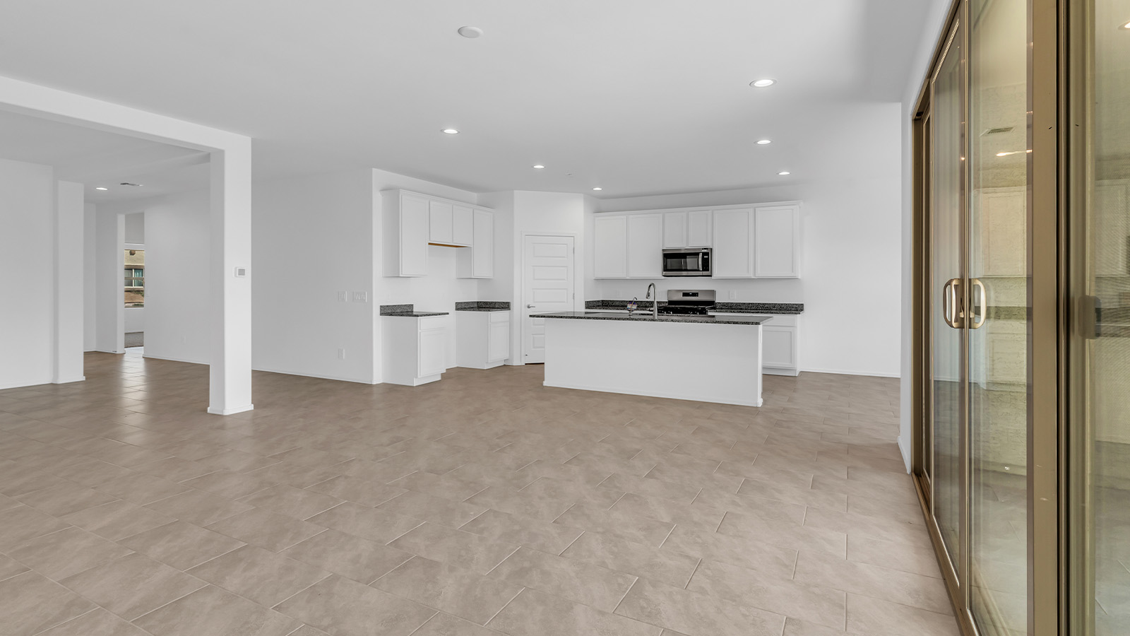 Welcome to The Pearl, a beautifully designed single-story new home located in the serene Cholla Ridge neighborhood of Saguaro Bloom. Spanning 2,431 square feet, this home offers four spacious bedrooms and three full bathrooms, making it an ideal choice for families who value both space and comfort.  As you enter through the front porch, you’re welcomed into a bright and open entryway that leads to the heart of the home. The expansive great room, dining area, and kitchen are seamlessly connected, providing a perfect setting for both everyday living and entertaining. The kitchen is a chef’s delight, featuring a large island, granite countertops, and Shaker-style cabinetry in double espresso. With a generously sized pantry and modern stainless steel gas appliances, this kitchen is both functional and stylish.  The Pearl’s layout includes a well-placed primary bedroom at the rear of the home, ensuring privacy and tranquility. The primary suite features a spacious walk-in closet and an en-suite bathroom with dual executive-height vanities and a large walk-in shower. The additional three bedrooms are located towards the front and sides of the home, each offering ample closet space and access to two full bathrooms, making this layout perfect for families and guests alike.  The outdoor living space is just as inviting, with a covered patio that extends from the great room, providing an ideal spot for enjoying Arizona’s beautiful weather. Whether you’re hosting a gathering or simply relaxing with a good book, this space is designed for your enjoyment.  The Pearl also features a dedicated utility room near the kitchen, making household tasks more convenient. A two-car garage offers plenty of space for vehicles and additional storage.  Built with energy efficiency and modern living in mind, The Pearl incorporates eco-friendly features and smart home technology, ensuring a comfortable and sustainable lifestyle. Large windows throughout the home allow natural light to flood the space, creating a warm and inviting atmosphere.  Located within the exclusive Cholla Ridge neighborhood at Saguaro Bloom, residents of The Pearl enjoy a range of amenities, including beautiful 12x24” tile flooring, and gourmet kitchens in select homes, all on lots with no rear neighbors. The community offers access to two pools, walking trails, and parks, all set against the stunning backdrop of the Tucson Mountains.  The Pearl combines style, comfort, and practicality, making it a perfect place to call home in one of Marana’s most sought-after communities.