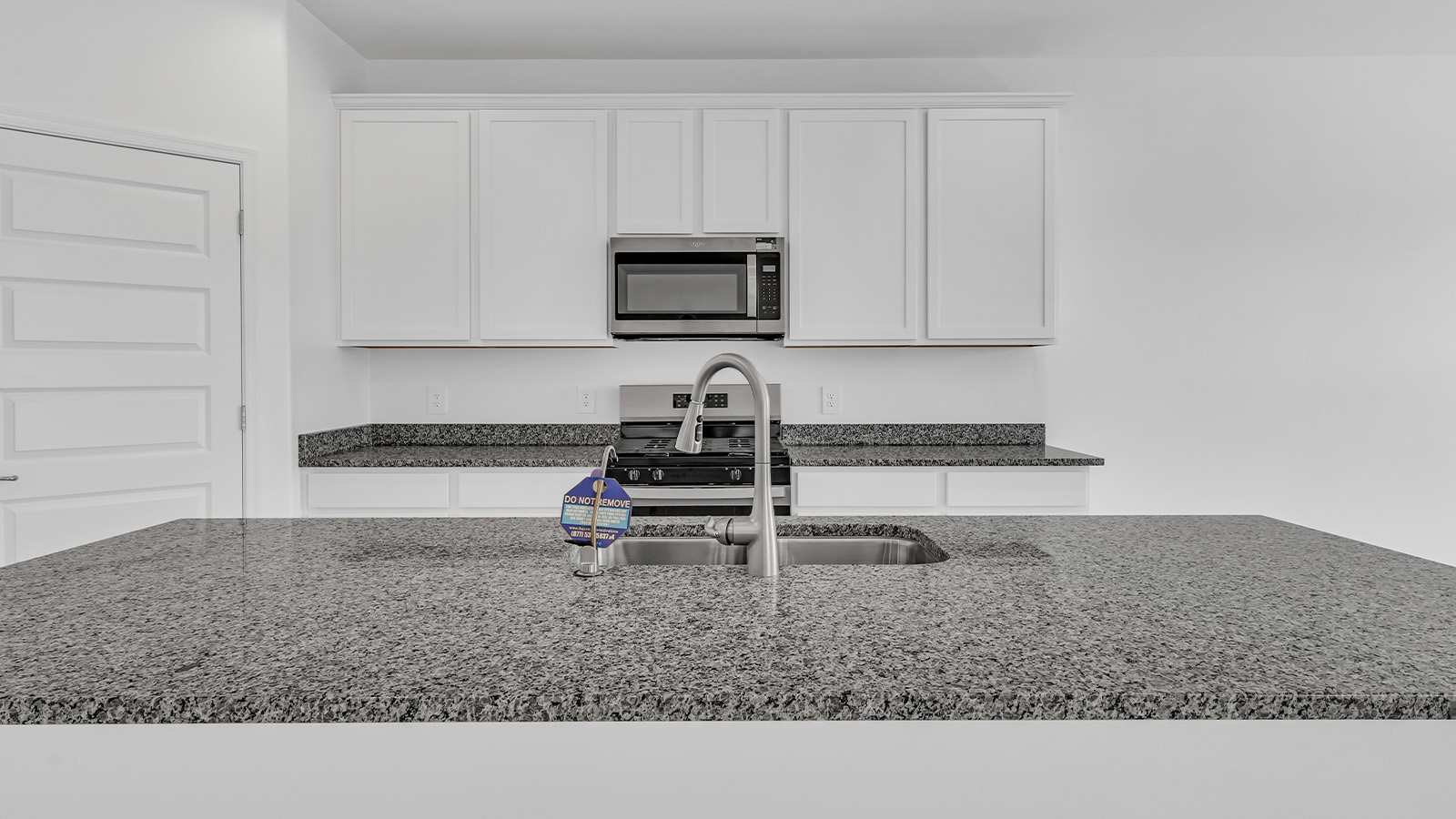 Welcome to The Pearl, a beautifully designed single-story new home located in the serene Cholla Ridge neighborhood of Saguaro Bloom. Spanning 2,431 square feet, this home offers four spacious bedrooms and three full bathrooms, making it an ideal choice for families who value both space and comfort.  As you enter through the front porch, you’re welcomed into a bright and open entryway that leads to the heart of the home. The expansive great room, dining area, and kitchen are seamlessly connected, providing a perfect setting for both everyday living and entertaining. The kitchen is a chef’s delight, featuring a large island, granite countertops, and Shaker-style cabinetry in double espresso. With a generously sized pantry and modern stainless steel gas appliances, this kitchen is both functional and stylish.  The Pearl’s layout includes a well-placed primary bedroom at the rear of the home, ensuring privacy and tranquility. The primary suite features a spacious walk-in closet and an en-suite bathroom with dual executive-height vanities and a large walk-in shower. The additional three bedrooms are located towards the front and sides of the home, each offering ample closet space and access to two full bathrooms, making this layout perfect for families and guests alike.  The outdoor living space is just as inviting, with a covered patio that extends from the great room, providing an ideal spot for enjoying Arizona’s beautiful weather. Whether you’re hosting a gathering or simply relaxing with a good book, this space is designed for your enjoyment.  The Pearl also features a dedicated utility room near the kitchen, making household tasks more convenient. A two-car garage offers plenty of space for vehicles and additional storage.  Built with energy efficiency and modern living in mind, The Pearl incorporates eco-friendly features and smart home technology, ensuring a comfortable and sustainable lifestyle. Large windows throughout the home allow natural light to flood the space, creating a warm and inviting atmosphere.  Located within the exclusive Cholla Ridge neighborhood at Saguaro Bloom, residents of The Pearl enjoy a range of amenities, including beautiful 12x24” tile flooring, and gourmet kitchens in select homes, all on lots with no rear neighbors. The community offers access to two pools, walking trails, and parks, all set against the stunning backdrop of the Tucson Mountains.  The Pearl combines style, comfort, and practicality, making it a perfect place to call home in one of Marana’s most sought-after communities.