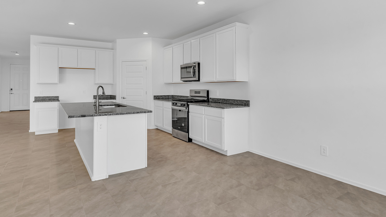 Welcome to The Pearl, a beautifully designed single-story new home located in the serene Cholla Ridge neighborhood of Saguaro Bloom. Spanning 2,431 square feet, this home offers four spacious bedrooms and three full bathrooms, making it an ideal choice for families who value both space and comfort.  As you enter through the front porch, you’re welcomed into a bright and open entryway that leads to the heart of the home. The expansive great room, dining area, and kitchen are seamlessly connected, providing a perfect setting for both everyday living and entertaining. The kitchen is a chef’s delight, featuring a large island, granite countertops, and Shaker-style cabinetry in double espresso. With a generously sized pantry and modern stainless steel gas appliances, this kitchen is both functional and stylish.  The Pearl’s layout includes a well-placed primary bedroom at the rear of the home, ensuring privacy and tranquility. The primary suite features a spacious walk-in closet and an en-suite bathroom with dual executive-height vanities and a large walk-in shower. The additional three bedrooms are located towards the front and sides of the home, each offering ample closet space and access to two full bathrooms, making this layout perfect for families and guests alike.  The outdoor living space is just as inviting, with a covered patio that extends from the great room, providing an ideal spot for enjoying Arizona’s beautiful weather. Whether you’re hosting a gathering or simply relaxing with a good book, this space is designed for your enjoyment.  The Pearl also features a dedicated utility room near the kitchen, making household tasks more convenient. A two-car garage offers plenty of space for vehicles and additional storage.  Built with energy efficiency and modern living in mind, The Pearl incorporates eco-friendly features and smart home technology, ensuring a comfortable and sustainable lifestyle. Large windows throughout the home allow natural light to flood the space, creating a warm and inviting atmosphere.  Located within the exclusive Cholla Ridge neighborhood at Saguaro Bloom, residents of The Pearl enjoy a range of amenities, including beautiful 12x24” tile flooring, and gourmet kitchens in select homes, all on lots with no rear neighbors. The community offers access to two pools, walking trails, and parks, all set against the stunning backdrop of the Tucson Mountains.  The Pearl combines style, comfort, and practicality, making it a perfect place to call home in one of Marana’s most sought-after communities.