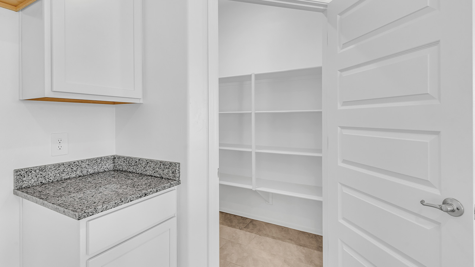 Welcome to The Pearl, a beautifully designed single-story new home located in the serene Cholla Ridge neighborhood of Saguaro Bloom. Spanning 2,431 square feet, this home offers four spacious bedrooms and three full bathrooms, making it an ideal choice for families who value both space and comfort.  As you enter through the front porch, you’re welcomed into a bright and open entryway that leads to the heart of the home. The expansive great room, dining area, and kitchen are seamlessly connected, providing a perfect setting for both everyday living and entertaining. The kitchen is a chef’s delight, featuring a large island, granite countertops, and Shaker-style cabinetry in double espresso. With a generously sized pantry and modern stainless steel gas appliances, this kitchen is both functional and stylish.  The Pearl’s layout includes a well-placed primary bedroom at the rear of the home, ensuring privacy and tranquility. The primary suite features a spacious walk-in closet and an en-suite bathroom with dual executive-height vanities and a large walk-in shower. The additional three bedrooms are located towards the front and sides of the home, each offering ample closet space and access to two full bathrooms, making this layout perfect for families and guests alike.  The outdoor living space is just as inviting, with a covered patio that extends from the great room, providing an ideal spot for enjoying Arizona’s beautiful weather. Whether you’re hosting a gathering or simply relaxing with a good book, this space is designed for your enjoyment.  The Pearl also features a dedicated utility room near the kitchen, making household tasks more convenient. A two-car garage offers plenty of space for vehicles and additional storage.  Built with energy efficiency and modern living in mind, The Pearl incorporates eco-friendly features and smart home technology, ensuring a comfortable and sustainable lifestyle. Large windows throughout the home allow natural light to flood the space, creating a warm and inviting atmosphere.  Located within the exclusive Cholla Ridge neighborhood at Saguaro Bloom, residents of The Pearl enjoy a range of amenities, including beautiful 12x24” tile flooring, and gourmet kitchens in select homes, all on lots with no rear neighbors. The community offers access to two pools, walking trails, and parks, all set against the stunning backdrop of the Tucson Mountains.  The Pearl combines style, comfort, and practicality, making it a perfect place to call home in one of Marana’s most sought-after communities.