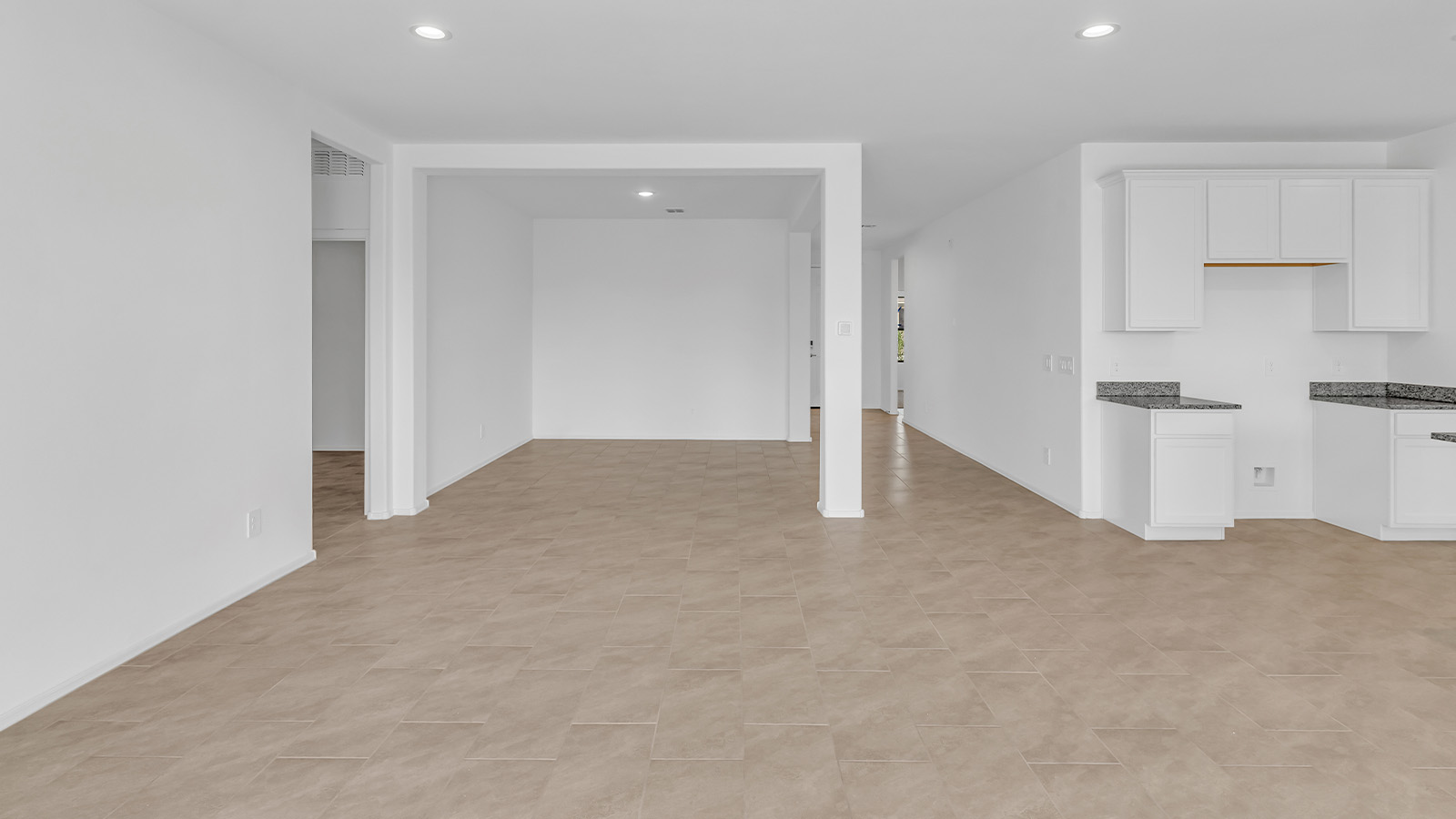 Welcome to The Pearl, a beautifully designed single-story new home located in the serene Cholla Ridge neighborhood of Saguaro Bloom. Spanning 2,431 square feet, this home offers four spacious bedrooms and three full bathrooms, making it an ideal choice for families who value both space and comfort.  As you enter through the front porch, you’re welcomed into a bright and open entryway that leads to the heart of the home. The expansive great room, dining area, and kitchen are seamlessly connected, providing a perfect setting for both everyday living and entertaining. The kitchen is a chef’s delight, featuring a large island, granite countertops, and Shaker-style cabinetry in double espresso. With a generously sized pantry and modern stainless steel gas appliances, this kitchen is both functional and stylish.  The Pearl’s layout includes a well-placed primary bedroom at the rear of the home, ensuring privacy and tranquility. The primary suite features a spacious walk-in closet and an en-suite bathroom with dual executive-height vanities and a large walk-in shower. The additional three bedrooms are located towards the front and sides of the home, each offering ample closet space and access to two full bathrooms, making this layout perfect for families and guests alike.  The outdoor living space is just as inviting, with a covered patio that extends from the great room, providing an ideal spot for enjoying Arizona’s beautiful weather. Whether you’re hosting a gathering or simply relaxing with a good book, this space is designed for your enjoyment.  The Pearl also features a dedicated utility room near the kitchen, making household tasks more convenient. A two-car garage offers plenty of space for vehicles and additional storage.  Built with energy efficiency and modern living in mind, The Pearl incorporates eco-friendly features and smart home technology, ensuring a comfortable and sustainable lifestyle. Large windows throughout the home allow natural light to flood the space, creating a warm and inviting atmosphere.  Located within the exclusive Cholla Ridge neighborhood at Saguaro Bloom, residents of The Pearl enjoy a range of amenities, including beautiful 12x24” tile flooring, and gourmet kitchens in select homes, all on lots with no rear neighbors. The community offers access to two pools, walking trails, and parks, all set against the stunning backdrop of the Tucson Mountains.  The Pearl combines style, comfort, and practicality, making it a perfect place to call home in one of Marana’s most sought-after communities.