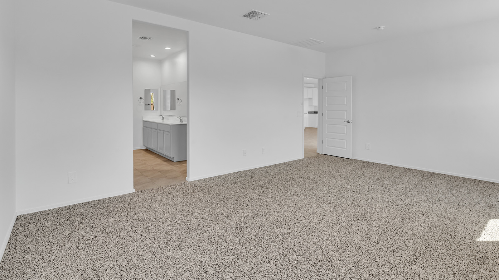 Welcome to The Pearl, a beautifully designed single-story new home located in the serene Cholla Ridge neighborhood of Saguaro Bloom. Spanning 2,431 square feet, this home offers four spacious bedrooms and three full bathrooms, making it an ideal choice for families who value both space and comfort.  As you enter through the front porch, you’re welcomed into a bright and open entryway that leads to the heart of the home. The expansive great room, dining area, and kitchen are seamlessly connected, providing a perfect setting for both everyday living and entertaining. The kitchen is a chef’s delight, featuring a large island, granite countertops, and Shaker-style cabinetry in double espresso. With a generously sized pantry and modern stainless steel gas appliances, this kitchen is both functional and stylish.  The Pearl’s layout includes a well-placed primary bedroom at the rear of the home, ensuring privacy and tranquility. The primary suite features a spacious walk-in closet and an en-suite bathroom with dual executive-height vanities and a large walk-in shower. The additional three bedrooms are located towards the front and sides of the home, each offering ample closet space and access to two full bathrooms, making this layout perfect for families and guests alike.  The outdoor living space is just as inviting, with a covered patio that extends from the great room, providing an ideal spot for enjoying Arizona’s beautiful weather. Whether you’re hosting a gathering or simply relaxing with a good book, this space is designed for your enjoyment.  The Pearl also features a dedicated utility room near the kitchen, making household tasks more convenient. A two-car garage offers plenty of space for vehicles and additional storage.  Built with energy efficiency and modern living in mind, The Pearl incorporates eco-friendly features and smart home technology, ensuring a comfortable and sustainable lifestyle. Large windows throughout the home allow natural light to flood the space, creating a warm and inviting atmosphere.  Located within the exclusive Cholla Ridge neighborhood at Saguaro Bloom, residents of The Pearl enjoy a range of amenities, including beautiful 12x24” tile flooring, and gourmet kitchens in select homes, all on lots with no rear neighbors. The community offers access to two pools, walking trails, and parks, all set against the stunning backdrop of the Tucson Mountains.  The Pearl combines style, comfort, and practicality, making it a perfect place to call home in one of Marana’s most sought-after communities.