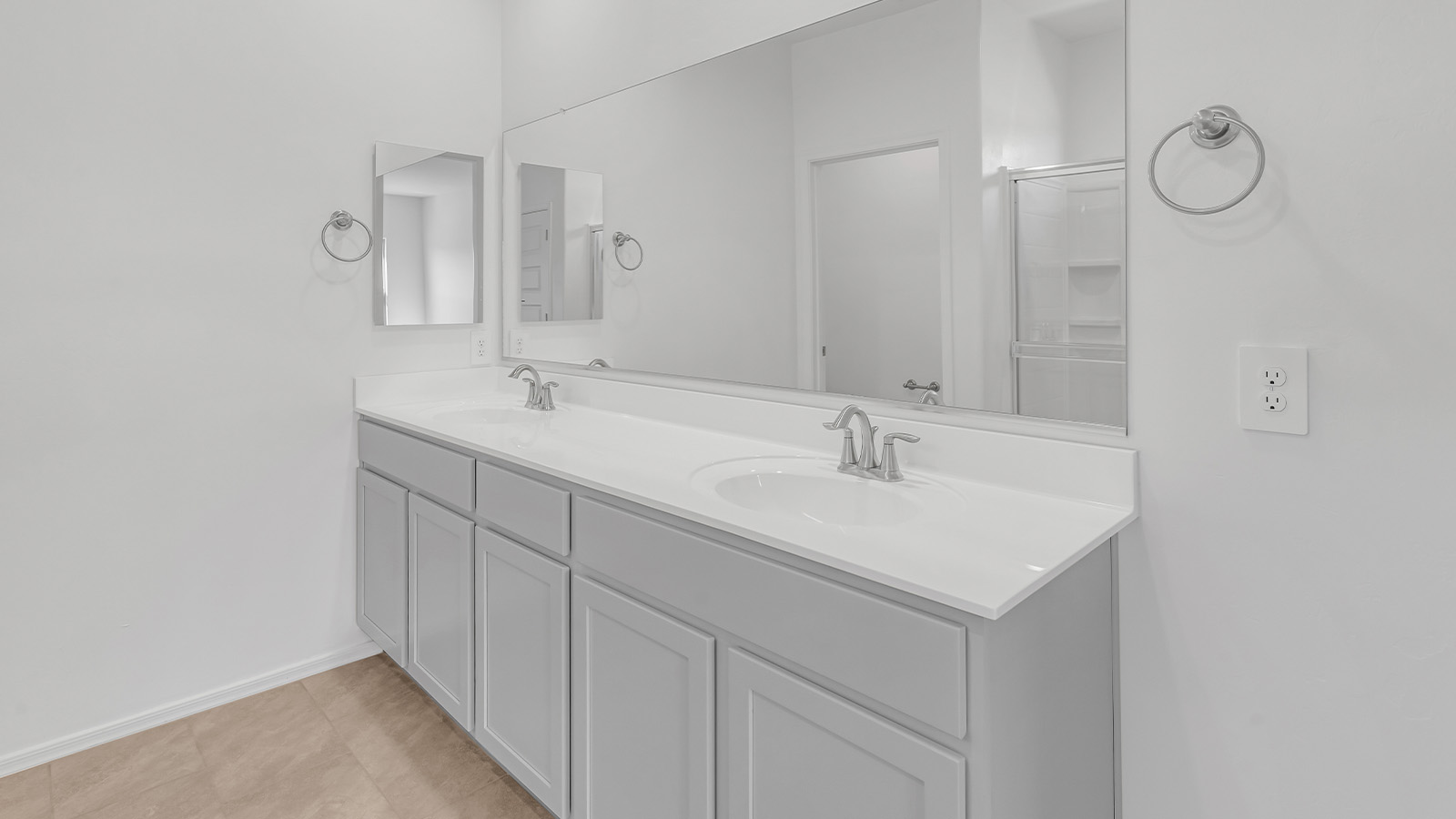 Welcome to The Pearl, a beautifully designed single-story new home located in the serene Cholla Ridge neighborhood of Saguaro Bloom. Spanning 2,431 square feet, this home offers four spacious bedrooms and three full bathrooms, making it an ideal choice for families who value both space and comfort.  As you enter through the front porch, you’re welcomed into a bright and open entryway that leads to the heart of the home. The expansive great room, dining area, and kitchen are seamlessly connected, providing a perfect setting for both everyday living and entertaining. The kitchen is a chef’s delight, featuring a large island, granite countertops, and Shaker-style cabinetry in double espresso. With a generously sized pantry and modern stainless steel gas appliances, this kitchen is both functional and stylish.  The Pearl’s layout includes a well-placed primary bedroom at the rear of the home, ensuring privacy and tranquility. The primary suite features a spacious walk-in closet and an en-suite bathroom with dual executive-height vanities and a large walk-in shower. The additional three bedrooms are located towards the front and sides of the home, each offering ample closet space and access to two full bathrooms, making this layout perfect for families and guests alike.  The outdoor living space is just as inviting, with a covered patio that extends from the great room, providing an ideal spot for enjoying Arizona’s beautiful weather. Whether you’re hosting a gathering or simply relaxing with a good book, this space is designed for your enjoyment.  The Pearl also features a dedicated utility room near the kitchen, making household tasks more convenient. A two-car garage offers plenty of space for vehicles and additional storage.  Built with energy efficiency and modern living in mind, The Pearl incorporates eco-friendly features and smart home technology, ensuring a comfortable and sustainable lifestyle. Large windows throughout the home allow natural light to flood the space, creating a warm and inviting atmosphere.  Located within the exclusive Cholla Ridge neighborhood at Saguaro Bloom, residents of The Pearl enjoy a range of amenities, including beautiful 12x24” tile flooring, and gourmet kitchens in select homes, all on lots with no rear neighbors. The community offers access to two pools, walking trails, and parks, all set against the stunning backdrop of the Tucson Mountains.  The Pearl combines style, comfort, and practicality, making it a perfect place to call home in one of Marana’s most sought-after communities.