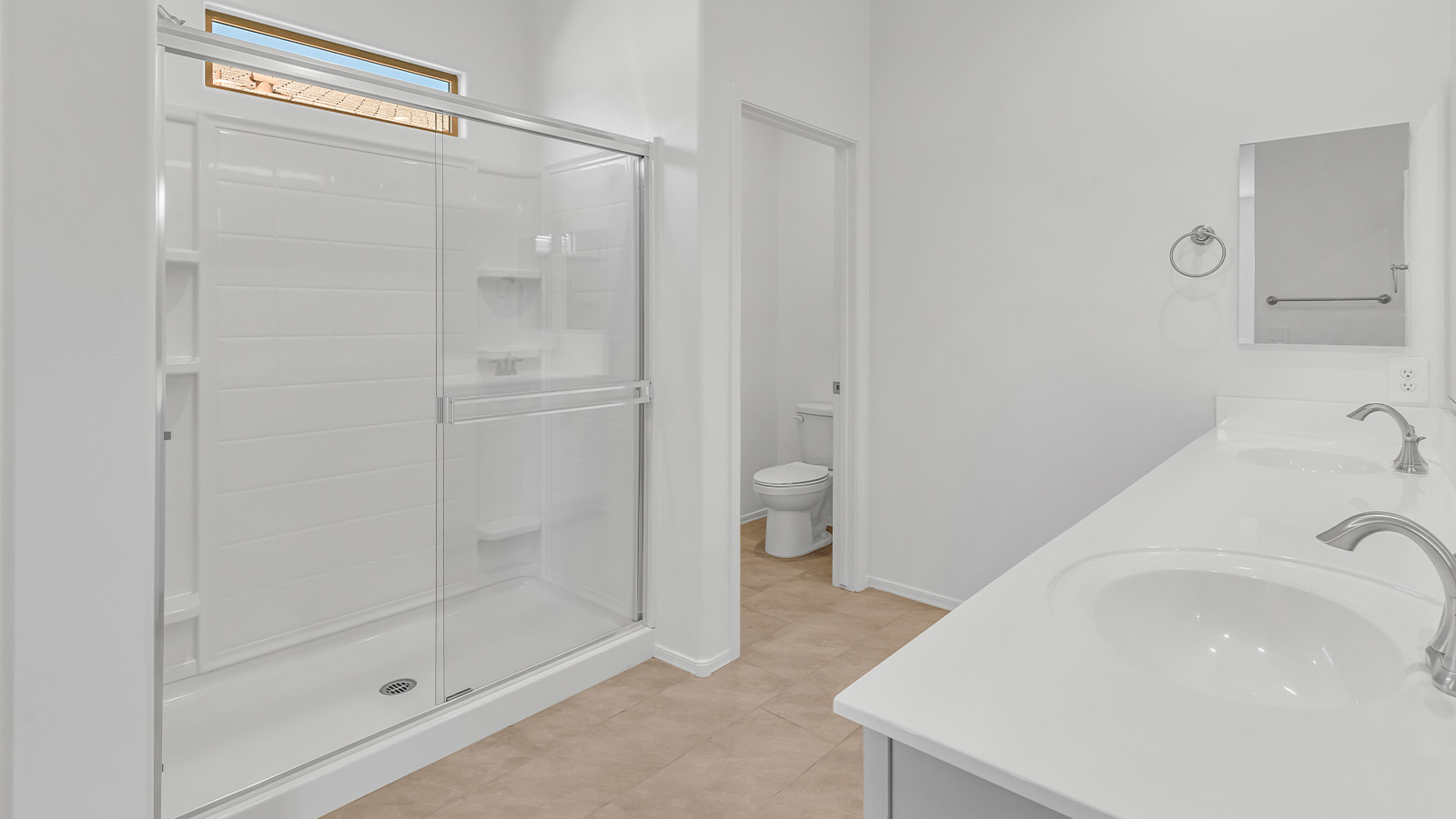 Welcome to The Pearl, a beautifully designed single-story new home located in the serene Cholla Ridge neighborhood of Saguaro Bloom. Spanning 2,431 square feet, this home offers four spacious bedrooms and three full bathrooms, making it an ideal choice for families who value both space and comfort.  As you enter through the front porch, you’re welcomed into a bright and open entryway that leads to the heart of the home. The expansive great room, dining area, and kitchen are seamlessly connected, providing a perfect setting for both everyday living and entertaining. The kitchen is a chef’s delight, featuring a large island, granite countertops, and Shaker-style cabinetry in double espresso. With a generously sized pantry and modern stainless steel gas appliances, this kitchen is both functional and stylish.  The Pearl’s layout includes a well-placed primary bedroom at the rear of the home, ensuring privacy and tranquility. The primary suite features a spacious walk-in closet and an en-suite bathroom with dual executive-height vanities and a large walk-in shower. The additional three bedrooms are located towards the front and sides of the home, each offering ample closet space and access to two full bathrooms, making this layout perfect for families and guests alike.  The outdoor living space is just as inviting, with a covered patio that extends from the great room, providing an ideal spot for enjoying Arizona’s beautiful weather. Whether you’re hosting a gathering or simply relaxing with a good book, this space is designed for your enjoyment.  The Pearl also features a dedicated utility room near the kitchen, making household tasks more convenient. A two-car garage offers plenty of space for vehicles and additional storage.  Built with energy efficiency and modern living in mind, The Pearl incorporates eco-friendly features and smart home technology, ensuring a comfortable and sustainable lifestyle. Large windows throughout the home allow natural light to flood the space, creating a warm and inviting atmosphere.  Located within the exclusive Cholla Ridge neighborhood at Saguaro Bloom, residents of The Pearl enjoy a range of amenities, including beautiful 12x24” tile flooring, and gourmet kitchens in select homes, all on lots with no rear neighbors. The community offers access to two pools, walking trails, and parks, all set against the stunning backdrop of the Tucson Mountains.  The Pearl combines style, comfort, and practicality, making it a perfect place to call home in one of Marana’s most sought-after communities.