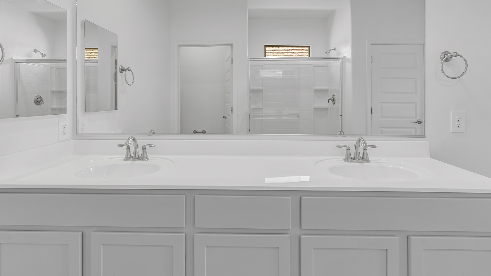 Welcome to The Pearl, a beautifully designed single-story new home located in the serene Cholla Ridge neighborhood of Saguaro Bloom. Spanning 2,431 square feet, this home offers four spacious bedrooms and three full bathrooms, making it an ideal choice for families who value both space and comfort.  As you enter through the front porch, you’re welcomed into a bright and open entryway that leads to the heart of the home. The expansive great room, dining area, and kitchen are seamlessly connected, providing a perfect setting for both everyday living and entertaining. The kitchen is a chef’s delight, featuring a large island, granite countertops, and Shaker-style cabinetry in double espresso. With a generously sized pantry and modern stainless steel gas appliances, this kitchen is both functional and stylish.  The Pearl’s layout includes a well-placed primary bedroom at the rear of the home, ensuring privacy and tranquility. The primary suite features a spacious walk-in closet and an en-suite bathroom with dual executive-height vanities and a large walk-in shower. The additional three bedrooms are located towards the front and sides of the home, each offering ample closet space and access to two full bathrooms, making this layout perfect for families and guests alike.  The outdoor living space is just as inviting, with a covered patio that extends from the great room, providing an ideal spot for enjoying Arizona’s beautiful weather. Whether you’re hosting a gathering or simply relaxing with a good book, this space is designed for your enjoyment.  The Pearl also features a dedicated utility room near the kitchen, making household tasks more convenient. A two-car garage offers plenty of space for vehicles and additional storage.  Built with energy efficiency and modern living in mind, The Pearl incorporates eco-friendly features and smart home technology, ensuring a comfortable and sustainable lifestyle. Large windows throughout the home allow natural light to flood the space, creating a warm and inviting atmosphere.  Located within the exclusive Cholla Ridge neighborhood at Saguaro Bloom, residents of The Pearl enjoy a range of amenities, including beautiful 12x24” tile flooring, and gourmet kitchens in select homes, all on lots with no rear neighbors. The community offers access to two pools, walking trails, and parks, all set against the stunning backdrop of the Tucson Mountains.  The Pearl combines style, comfort, and practicality, making it a perfect place to call home in one of Marana’s most sought-after communities.