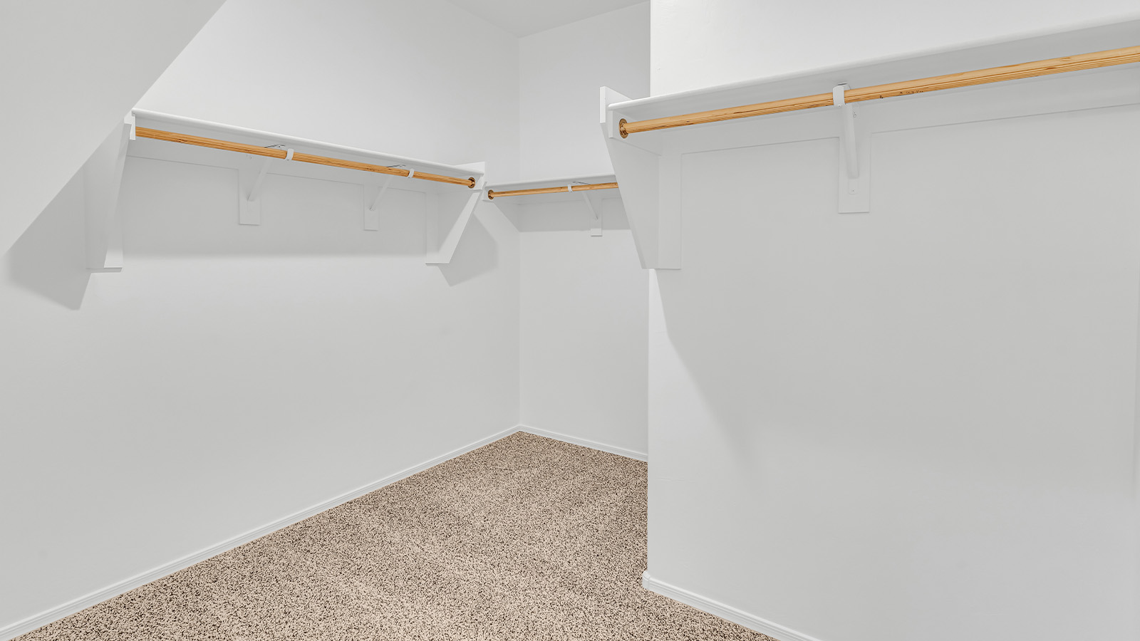 Welcome to The Pearl, a beautifully designed single-story new home located in the serene Cholla Ridge neighborhood of Saguaro Bloom. Spanning 2,431 square feet, this home offers four spacious bedrooms and three full bathrooms, making it an ideal choice for families who value both space and comfort.  As you enter through the front porch, you’re welcomed into a bright and open entryway that leads to the heart of the home. The expansive great room, dining area, and kitchen are seamlessly connected, providing a perfect setting for both everyday living and entertaining. The kitchen is a chef’s delight, featuring a large island, granite countertops, and Shaker-style cabinetry in double espresso. With a generously sized pantry and modern stainless steel gas appliances, this kitchen is both functional and stylish.  The Pearl’s layout includes a well-placed primary bedroom at the rear of the home, ensuring privacy and tranquility. The primary suite features a spacious walk-in closet and an en-suite bathroom with dual executive-height vanities and a large walk-in shower. The additional three bedrooms are located towards the front and sides of the home, each offering ample closet space and access to two full bathrooms, making this layout perfect for families and guests alike.  The outdoor living space is just as inviting, with a covered patio that extends from the great room, providing an ideal spot for enjoying Arizona’s beautiful weather. Whether you’re hosting a gathering or simply relaxing with a good book, this space is designed for your enjoyment.  The Pearl also features a dedicated utility room near the kitchen, making household tasks more convenient. A two-car garage offers plenty of space for vehicles and additional storage.  Built with energy efficiency and modern living in mind, The Pearl incorporates eco-friendly features and smart home technology, ensuring a comfortable and sustainable lifestyle. Large windows throughout the home allow natural light to flood the space, creating a warm and inviting atmosphere.  Located within the exclusive Cholla Ridge neighborhood at Saguaro Bloom, residents of The Pearl enjoy a range of amenities, including beautiful 12x24” tile flooring, and gourmet kitchens in select homes, all on lots with no rear neighbors. The community offers access to two pools, walking trails, and parks, all set against the stunning backdrop of the Tucson Mountains.  The Pearl combines style, comfort, and practicality, making it a perfect place to call home in one of Marana’s most sought-after communities.