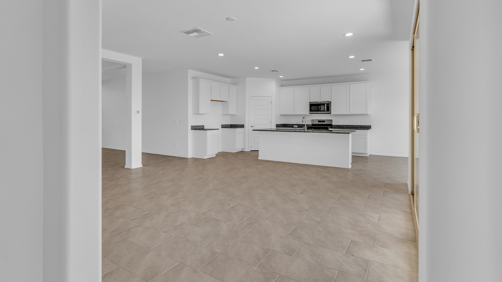 Welcome to The Pearl, a beautifully designed single-story new home located in the serene Cholla Ridge neighborhood of Saguaro Bloom. Spanning 2,431 square feet, this home offers four spacious bedrooms and three full bathrooms, making it an ideal choice for families who value both space and comfort.  As you enter through the front porch, you’re welcomed into a bright and open entryway that leads to the heart of the home. The expansive great room, dining area, and kitchen are seamlessly connected, providing a perfect setting for both everyday living and entertaining. The kitchen is a chef’s delight, featuring a large island, granite countertops, and Shaker-style cabinetry in double espresso. With a generously sized pantry and modern stainless steel gas appliances, this kitchen is both functional and stylish.  The Pearl’s layout includes a well-placed primary bedroom at the rear of the home, ensuring privacy and tranquility. The primary suite features a spacious walk-in closet and an en-suite bathroom with dual executive-height vanities and a large walk-in shower. The additional three bedrooms are located towards the front and sides of the home, each offering ample closet space and access to two full bathrooms, making this layout perfect for families and guests alike.  The outdoor living space is just as inviting, with a covered patio that extends from the great room, providing an ideal spot for enjoying Arizona’s beautiful weather. Whether you’re hosting a gathering or simply relaxing with a good book, this space is designed for your enjoyment.  The Pearl also features a dedicated utility room near the kitchen, making household tasks more convenient. A two-car garage offers plenty of space for vehicles and additional storage.  Built with energy efficiency and modern living in mind, The Pearl incorporates eco-friendly features and smart home technology, ensuring a comfortable and sustainable lifestyle. Large windows throughout the home allow natural light to flood the space, creating a warm and inviting atmosphere.  Located within the exclusive Cholla Ridge neighborhood at Saguaro Bloom, residents of The Pearl enjoy a range of amenities, including beautiful 12x24” tile flooring, and gourmet kitchens in select homes, all on lots with no rear neighbors. The community offers access to two pools, walking trails, and parks, all set against the stunning backdrop of the Tucson Mountains.  The Pearl combines style, comfort, and practicality, making it a perfect place to call home in one of Marana’s most sought-after communities.