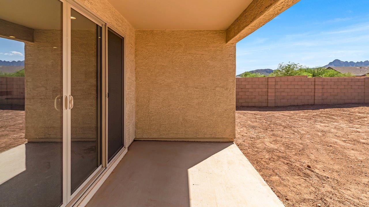 Welcome to The Pearl, a beautifully designed single-story new home located in the serene Cholla Ridge neighborhood of Saguaro Bloom. Spanning 2,431 square feet, this home offers four spacious bedrooms and three full bathrooms, making it an ideal choice for families who value both space and comfort.  As you enter through the front porch, you’re welcomed into a bright and open entryway that leads to the heart of the home. The expansive great room, dining area, and kitchen are seamlessly connected, providing a perfect setting for both everyday living and entertaining. The kitchen is a chef’s delight, featuring a large island, granite countertops, and Shaker-style cabinetry in double espresso. With a generously sized pantry and modern stainless steel gas appliances, this kitchen is both functional and stylish.  The Pearl’s layout includes a well-placed primary bedroom at the rear of the home, ensuring privacy and tranquility. The primary suite features a spacious walk-in closet and an en-suite bathroom with dual executive-height vanities and a large walk-in shower. The additional three bedrooms are located towards the front and sides of the home, each offering ample closet space and access to two full bathrooms, making this layout perfect for families and guests alike.  The outdoor living space is just as inviting, with a covered patio that extends from the great room, providing an ideal spot for enjoying Arizona’s beautiful weather. Whether you’re hosting a gathering or simply relaxing with a good book, this space is designed for your enjoyment.  The Pearl also features a dedicated utility room near the kitchen, making household tasks more convenient. A two-car garage offers plenty of space for vehicles and additional storage.  Built with energy efficiency and modern living in mind, The Pearl incorporates eco-friendly features and smart home technology, ensuring a comfortable and sustainable lifestyle. Large windows throughout the home allow natural light to flood the space, creating a warm and inviting atmosphere.  Located within the exclusive Cholla Ridge neighborhood at Saguaro Bloom, residents of The Pearl enjoy a range of amenities, including beautiful 12x24” tile flooring, and gourmet kitchens in select homes, all on lots with no rear neighbors. The community offers access to two pools, walking trails, and parks, all set against the stunning backdrop of the Tucson Mountains.  The Pearl combines style, comfort, and practicality, making it a perfect place to call home in one of Marana’s most sought-after communities.