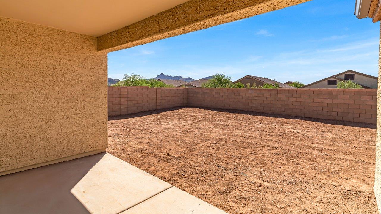 Welcome to The Pearl, a beautifully designed single-story new home located in the serene Cholla Ridge neighborhood of Saguaro Bloom. Spanning 2,431 square feet, this home offers four spacious bedrooms and three full bathrooms, making it an ideal choice for families who value both space and comfort.  As you enter through the front porch, you’re welcomed into a bright and open entryway that leads to the heart of the home. The expansive great room, dining area, and kitchen are seamlessly connected, providing a perfect setting for both everyday living and entertaining. The kitchen is a chef’s delight, featuring a large island, granite countertops, and Shaker-style cabinetry in double espresso. With a generously sized pantry and modern stainless steel gas appliances, this kitchen is both functional and stylish.  The Pearl’s layout includes a well-placed primary bedroom at the rear of the home, ensuring privacy and tranquility. The primary suite features a spacious walk-in closet and an en-suite bathroom with dual executive-height vanities and a large walk-in shower. The additional three bedrooms are located towards the front and sides of the home, each offering ample closet space and access to two full bathrooms, making this layout perfect for families and guests alike.  The outdoor living space is just as inviting, with a covered patio that extends from the great room, providing an ideal spot for enjoying Arizona’s beautiful weather. Whether you’re hosting a gathering or simply relaxing with a good book, this space is designed for your enjoyment.  The Pearl also features a dedicated utility room near the kitchen, making household tasks more convenient. A two-car garage offers plenty of space for vehicles and additional storage.  Built with energy efficiency and modern living in mind, The Pearl incorporates eco-friendly features and smart home technology, ensuring a comfortable and sustainable lifestyle. Large windows throughout the home allow natural light to flood the space, creating a warm and inviting atmosphere.  Located within the exclusive Cholla Ridge neighborhood at Saguaro Bloom, residents of The Pearl enjoy a range of amenities, including beautiful 12x24” tile flooring, and gourmet kitchens in select homes, all on lots with no rear neighbors. The community offers access to two pools, walking trails, and parks, all set against the stunning backdrop of the Tucson Mountains.  The Pearl combines style, comfort, and practicality, making it a perfect place to call home in one of Marana’s most sought-after communities.