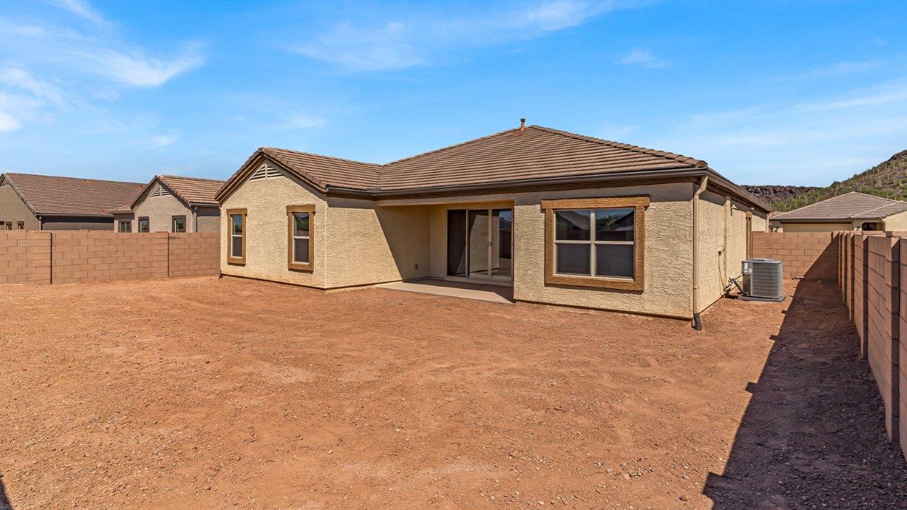 Welcome to The Pearl, a beautifully designed single-story new home located in the serene Cholla Ridge neighborhood of Saguaro Bloom. Spanning 2,431 square feet, this home offers four spacious bedrooms and three full bathrooms, making it an ideal choice for families who value both space and comfort.  As you enter through the front porch, you’re welcomed into a bright and open entryway that leads to the heart of the home. The expansive great room, dining area, and kitchen are seamlessly connected, providing a perfect setting for both everyday living and entertaining. The kitchen is a chef’s delight, featuring a large island, granite countertops, and Shaker-style cabinetry in double espresso. With a generously sized pantry and modern stainless steel gas appliances, this kitchen is both functional and stylish.  The Pearl’s layout includes a well-placed primary bedroom at the rear of the home, ensuring privacy and tranquility. The primary suite features a spacious walk-in closet and an en-suite bathroom with dual executive-height vanities and a large walk-in shower. The additional three bedrooms are located towards the front and sides of the home, each offering ample closet space and access to two full bathrooms, making this layout perfect for families and guests alike.  The outdoor living space is just as inviting, with a covered patio that extends from the great room, providing an ideal spot for enjoying Arizona’s beautiful weather. Whether you’re hosting a gathering or simply relaxing with a good book, this space is designed for your enjoyment.  The Pearl also features a dedicated utility room near the kitchen, making household tasks more convenient. A two-car garage offers plenty of space for vehicles and additional storage.  Built with energy efficiency and modern living in mind, The Pearl incorporates eco-friendly features and smart home technology, ensuring a comfortable and sustainable lifestyle. Large windows throughout the home allow natural light to flood the space, creating a warm and inviting atmosphere.  Located within the exclusive Cholla Ridge neighborhood at Saguaro Bloom, residents of The Pearl enjoy a range of amenities, including beautiful 12x24” tile flooring, and gourmet kitchens in select homes, all on lots with no rear neighbors. The community offers access to two pools, walking trails, and parks, all set against the stunning backdrop of the Tucson Mountains.  The Pearl combines style, comfort, and practicality, making it a perfect place to call home in one of Marana’s most sought-after communities.