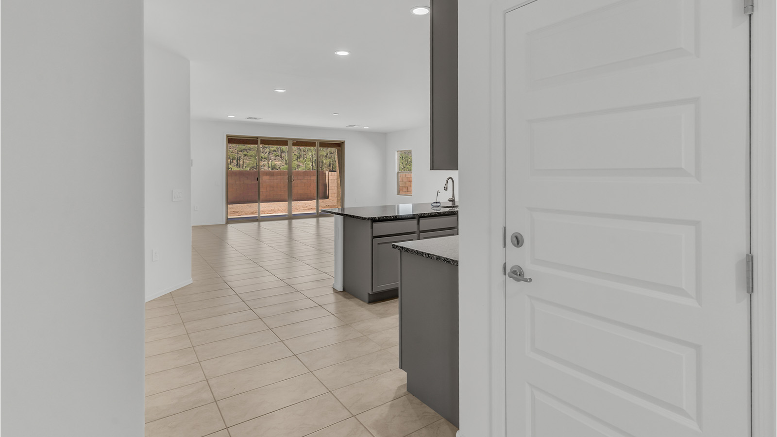 Welcome to The Citrine, a spacious single-story new home located in the tranquil Cholla Ridge neighborhood of Saguaro Bloom. With 2,577 square feet of well-planned living space, this home offers four bedrooms, three bathrooms, and a dedicated study, making it ideal for families who value both space and convenience.  As you enter through the inviting covered porch, you’re greeted by a bright and airy entryway that flows into the heart of the home. The expansive great room, dining area, and kitchen are thoughtfully connected, creating an ideal space for entertaining or simply enjoying time with family. The kitchen is a chef's dream, featuring a large island, granite countertops, and Shaker-style cabinetry in double espresso. A spacious pantry and modern stainless steel gas appliances ensure that this kitchen is both functional and stylish.  The Citrine’s layout includes a generously sized primary bedroom, carefully positioned for privacy at the rear of the home. This room features a large walk-in closet and an en-suite bathroom with dual executive-height vanities and a luxurious super shower. The additional three bedrooms are well-sized and located in separate areas of the home, ensuring privacy and easy access to two more full bathrooms.  One of the highlights of The Citrine is its versatile study, which can be used as a home office, library, media room, or extra bedroom depending on your needs. The large laundry room, conveniently situated near the bedrooms, adds to the home’s practicality.  The covered patio, accessible from the great room, offers a perfect spot for outdoor living, where you can enjoy Arizona’s beautiful weather throughout the year. Whether you’re hosting a barbecue or simply relaxing, this outdoor space enhances the home’s appeal.  Designed with energy efficiency and modern living in mind, The Citrine includes eco-friendly features and smart home technology, ensuring comfort and sustainability. Large windows throughout the home allow natural light to brighten every corner, creating a warm and welcoming atmosphere.  Located within the exclusive Cholla Ridge neighborhood at Saguaro Bloom, residents of The Citrine enjoy a range of premium features, including beautiful 12x24” tile flooring, gourmet kitchens, and 10’ ceilings in select homes. The community offers access to two pools, walking trails, parks, and more, all set against the picturesque backdrop of the Tucson Mountains.  The Citrine combines style, comfort, and practicality, making it a perfect place to call home in one of Marana’s most sought-after communities.