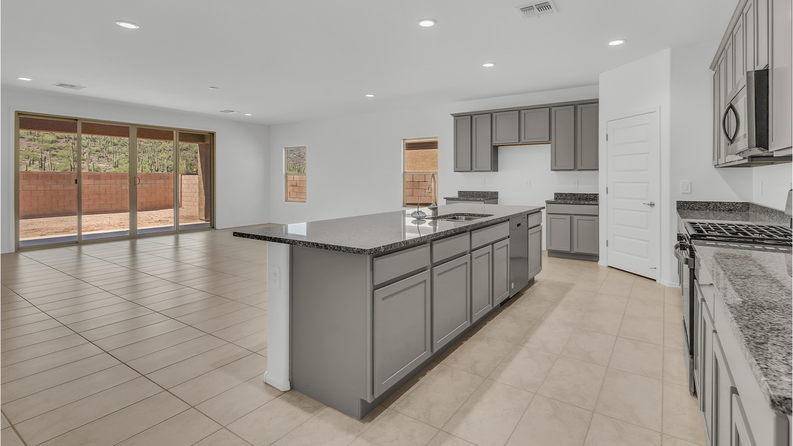 Welcome to The Citrine, a spacious single-story new home located in the tranquil Cholla Ridge neighborhood of Saguaro Bloom. With 2,577 square feet of well-planned living space, this home offers four bedrooms, three bathrooms, and a dedicated study, making it ideal for families who value both space and convenience.  As you enter through the inviting covered porch, you’re greeted by a bright and airy entryway that flows into the heart of the home. The expansive great room, dining area, and kitchen are thoughtfully connected, creating an ideal space for entertaining or simply enjoying time with family. The kitchen is a chef's dream, featuring a large island, granite countertops, and Shaker-style cabinetry in double espresso. A spacious pantry and modern stainless steel gas appliances ensure that this kitchen is both functional and stylish.  The Citrine’s layout includes a generously sized primary bedroom, carefully positioned for privacy at the rear of the home. This room features a large walk-in closet and an en-suite bathroom with dual executive-height vanities and a luxurious super shower. The additional three bedrooms are well-sized and located in separate areas of the home, ensuring privacy and easy access to two more full bathrooms.  One of the highlights of The Citrine is its versatile study, which can be used as a home office, library, media room, or extra bedroom depending on your needs. The large laundry room, conveniently situated near the bedrooms, adds to the home’s practicality.  The covered patio, accessible from the great room, offers a perfect spot for outdoor living, where you can enjoy Arizona’s beautiful weather throughout the year. Whether you’re hosting a barbecue or simply relaxing, this outdoor space enhances the home’s appeal.  Designed with energy efficiency and modern living in mind, The Citrine includes eco-friendly features and smart home technology, ensuring comfort and sustainability. Large windows throughout the home allow natural light to brighten every corner, creating a warm and welcoming atmosphere.  Located within the exclusive Cholla Ridge neighborhood at Saguaro Bloom, residents of The Citrine enjoy a range of premium features, including beautiful 12x24” tile flooring, gourmet kitchens, and 10’ ceilings in select homes. The community offers access to two pools, walking trails, parks, and more, all set against the picturesque backdrop of the Tucson Mountains.  The Citrine combines style, comfort, and practicality, making it a perfect place to call home in one of Marana’s most sought-after communities.