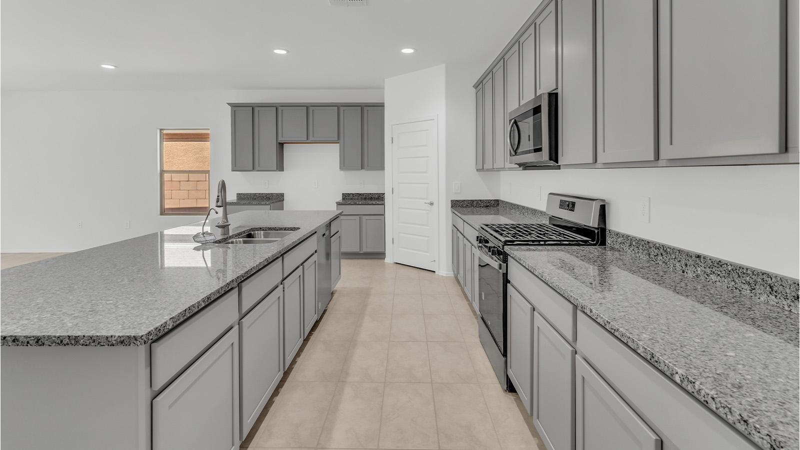 Welcome to The Citrine, a spacious single-story new home located in the tranquil Cholla Ridge neighborhood of Saguaro Bloom. With 2,577 square feet of well-planned living space, this home offers four bedrooms, three bathrooms, and a dedicated study, making it ideal for families who value both space and convenience.  As you enter through the inviting covered porch, you’re greeted by a bright and airy entryway that flows into the heart of the home. The expansive great room, dining area, and kitchen are thoughtfully connected, creating an ideal space for entertaining or simply enjoying time with family. The kitchen is a chef's dream, featuring a large island, granite countertops, and Shaker-style cabinetry in double espresso. A spacious pantry and modern stainless steel gas appliances ensure that this kitchen is both functional and stylish.  The Citrine’s layout includes a generously sized primary bedroom, carefully positioned for privacy at the rear of the home. This room features a large walk-in closet and an en-suite bathroom with dual executive-height vanities and a luxurious super shower. The additional three bedrooms are well-sized and located in separate areas of the home, ensuring privacy and easy access to two more full bathrooms.  One of the highlights of The Citrine is its versatile study, which can be used as a home office, library, media room, or extra bedroom depending on your needs. The large laundry room, conveniently situated near the bedrooms, adds to the home’s practicality.  The covered patio, accessible from the great room, offers a perfect spot for outdoor living, where you can enjoy Arizona’s beautiful weather throughout the year. Whether you’re hosting a barbecue or simply relaxing, this outdoor space enhances the home’s appeal.  Designed with energy efficiency and modern living in mind, The Citrine includes eco-friendly features and smart home technology, ensuring comfort and sustainability. Large windows throughout the home allow natural light to brighten every corner, creating a warm and welcoming atmosphere.  Located within the exclusive Cholla Ridge neighborhood at Saguaro Bloom, residents of The Citrine enjoy a range of premium features, including beautiful 12x24” tile flooring, gourmet kitchens, and 10’ ceilings in select homes. The community offers access to two pools, walking trails, parks, and more, all set against the picturesque backdrop of the Tucson Mountains.  The Citrine combines style, comfort, and practicality, making it a perfect place to call home in one of Marana’s most sought-after communities.