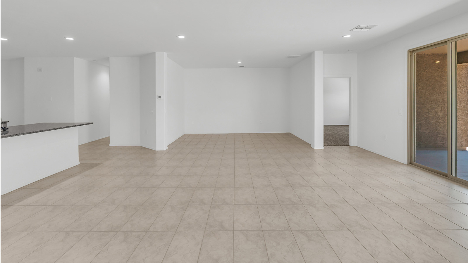 Welcome to The Citrine, a spacious single-story new home located in the tranquil Cholla Ridge neighborhood of Saguaro Bloom. With 2,577 square feet of well-planned living space, this home offers four bedrooms, three bathrooms, and a dedicated study, making it ideal for families who value both space and convenience.  As you enter through the inviting covered porch, you’re greeted by a bright and airy entryway that flows into the heart of the home. The expansive great room, dining area, and kitchen are thoughtfully connected, creating an ideal space for entertaining or simply enjoying time with family. The kitchen is a chef's dream, featuring a large island, granite countertops, and Shaker-style cabinetry in double espresso. A spacious pantry and modern stainless steel gas appliances ensure that this kitchen is both functional and stylish.  The Citrine’s layout includes a generously sized primary bedroom, carefully positioned for privacy at the rear of the home. This room features a large walk-in closet and an en-suite bathroom with dual executive-height vanities and a luxurious super shower. The additional three bedrooms are well-sized and located in separate areas of the home, ensuring privacy and easy access to two more full bathrooms.  One of the highlights of The Citrine is its versatile study, which can be used as a home office, library, media room, or extra bedroom depending on your needs. The large laundry room, conveniently situated near the bedrooms, adds to the home’s practicality.  The covered patio, accessible from the great room, offers a perfect spot for outdoor living, where you can enjoy Arizona’s beautiful weather throughout the year. Whether you’re hosting a barbecue or simply relaxing, this outdoor space enhances the home’s appeal.  Designed with energy efficiency and modern living in mind, The Citrine includes eco-friendly features and smart home technology, ensuring comfort and sustainability. Large windows throughout the home allow natural light to brighten every corner, creating a warm and welcoming atmosphere.  Located within the exclusive Cholla Ridge neighborhood at Saguaro Bloom, residents of The Citrine enjoy a range of premium features, including beautiful 12x24” tile flooring, gourmet kitchens, and 10’ ceilings in select homes. The community offers access to two pools, walking trails, parks, and more, all set against the picturesque backdrop of the Tucson Mountains.  The Citrine combines style, comfort, and practicality, making it a perfect place to call home in one of Marana’s most sought-after communities.