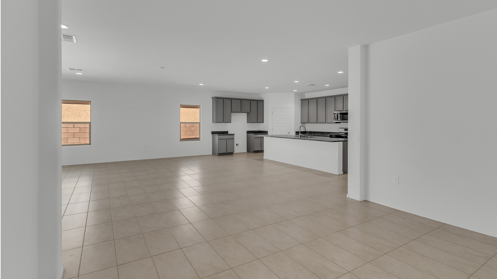 Welcome to The Citrine, a spacious single-story new home located in the tranquil Cholla Ridge neighborhood of Saguaro Bloom. With 2,577 square feet of well-planned living space, this home offers four bedrooms, three bathrooms, and a dedicated study, making it ideal for families who value both space and convenience.  As you enter through the inviting covered porch, you’re greeted by a bright and airy entryway that flows into the heart of the home. The expansive great room, dining area, and kitchen are thoughtfully connected, creating an ideal space for entertaining or simply enjoying time with family. The kitchen is a chef's dream, featuring a large island, granite countertops, and Shaker-style cabinetry in double espresso. A spacious pantry and modern stainless steel gas appliances ensure that this kitchen is both functional and stylish.  The Citrine’s layout includes a generously sized primary bedroom, carefully positioned for privacy at the rear of the home. This room features a large walk-in closet and an en-suite bathroom with dual executive-height vanities and a luxurious super shower. The additional three bedrooms are well-sized and located in separate areas of the home, ensuring privacy and easy access to two more full bathrooms.  One of the highlights of The Citrine is its versatile study, which can be used as a home office, library, media room, or extra bedroom depending on your needs. The large laundry room, conveniently situated near the bedrooms, adds to the home’s practicality.  The covered patio, accessible from the great room, offers a perfect spot for outdoor living, where you can enjoy Arizona’s beautiful weather throughout the year. Whether you’re hosting a barbecue or simply relaxing, this outdoor space enhances the home’s appeal.  Designed with energy efficiency and modern living in mind, The Citrine includes eco-friendly features and smart home technology, ensuring comfort and sustainability. Large windows throughout the home allow natural light to brighten every corner, creating a warm and welcoming atmosphere.  Located within the exclusive Cholla Ridge neighborhood at Saguaro Bloom, residents of The Citrine enjoy a range of premium features, including beautiful 12x24” tile flooring, gourmet kitchens, and 10’ ceilings in select homes. The community offers access to two pools, walking trails, parks, and more, all set against the picturesque backdrop of the Tucson Mountains.  The Citrine combines style, comfort, and practicality, making it a perfect place to call home in one of Marana’s most sought-after communities.